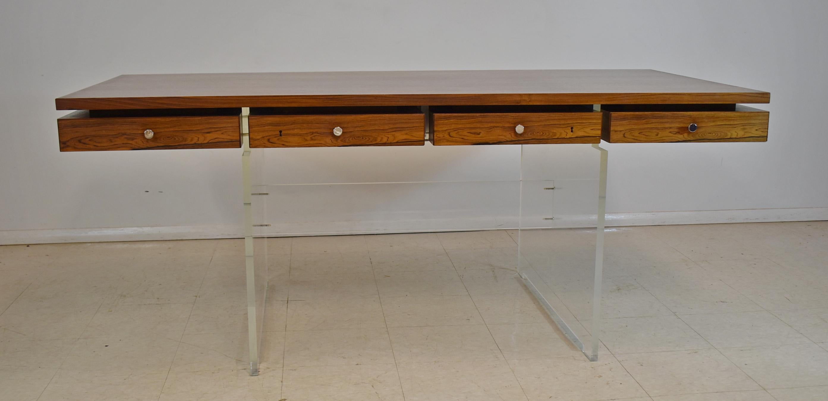 Modern four drawer acrylic and rosewood desk by Poul Norreklit. Acrylic base is 3/4