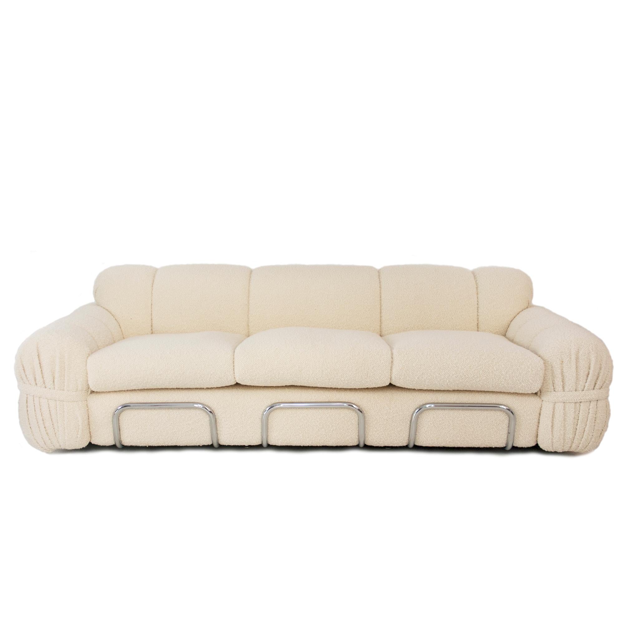 Modern sofa designed by italian designer and painter Adriano Piazzesi (1923 - 2009) in the 1970s. The sofa is supported by a curved steel structure that holds the 3 pax wood and foam body reupholstered in beige cotton bouclé.
 