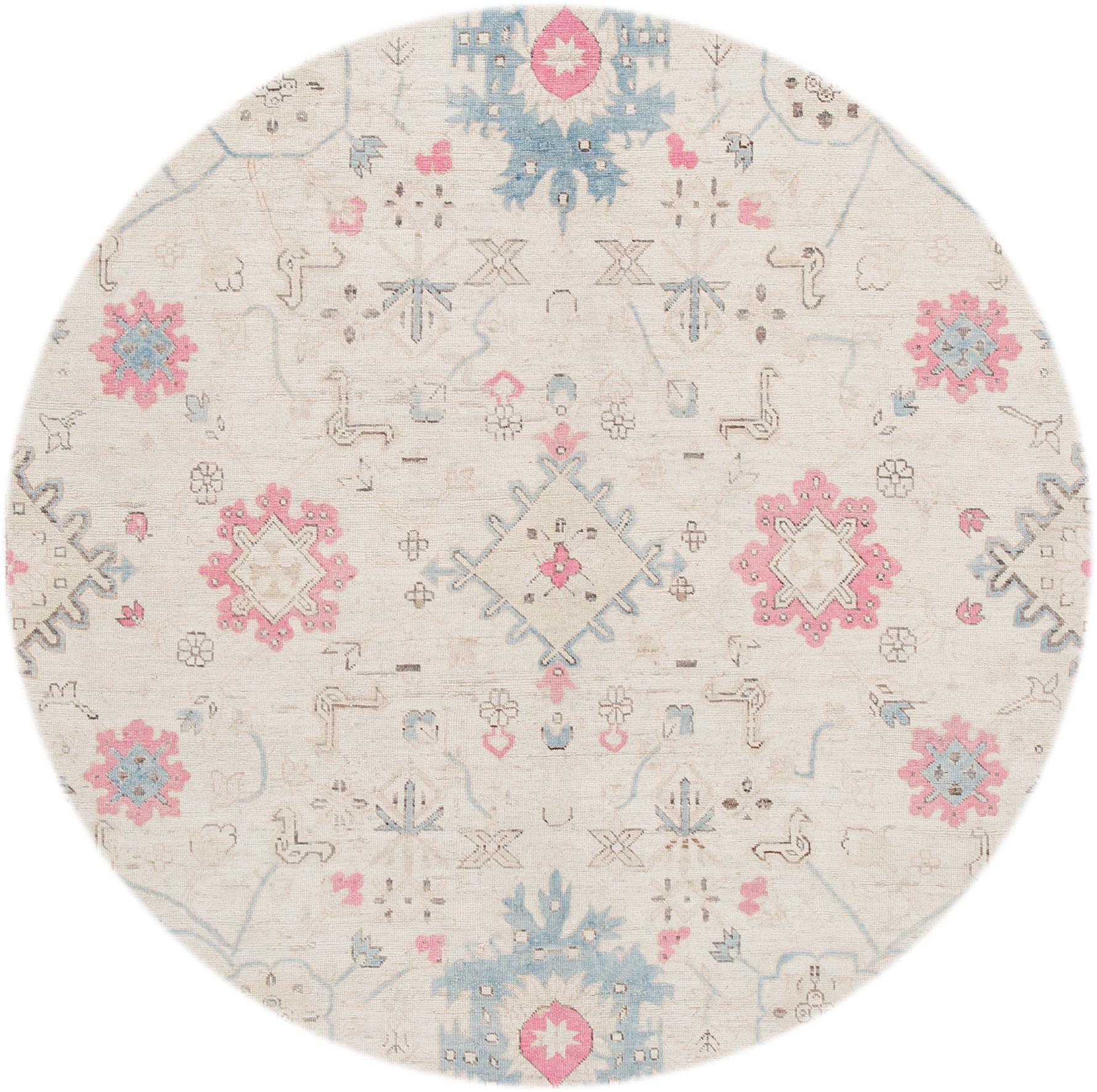 Beautiful modern hand knotted Khotan wool rug. This rug has an ivory field with blue and red floral accents all-over. 

This rug measures 8' 9