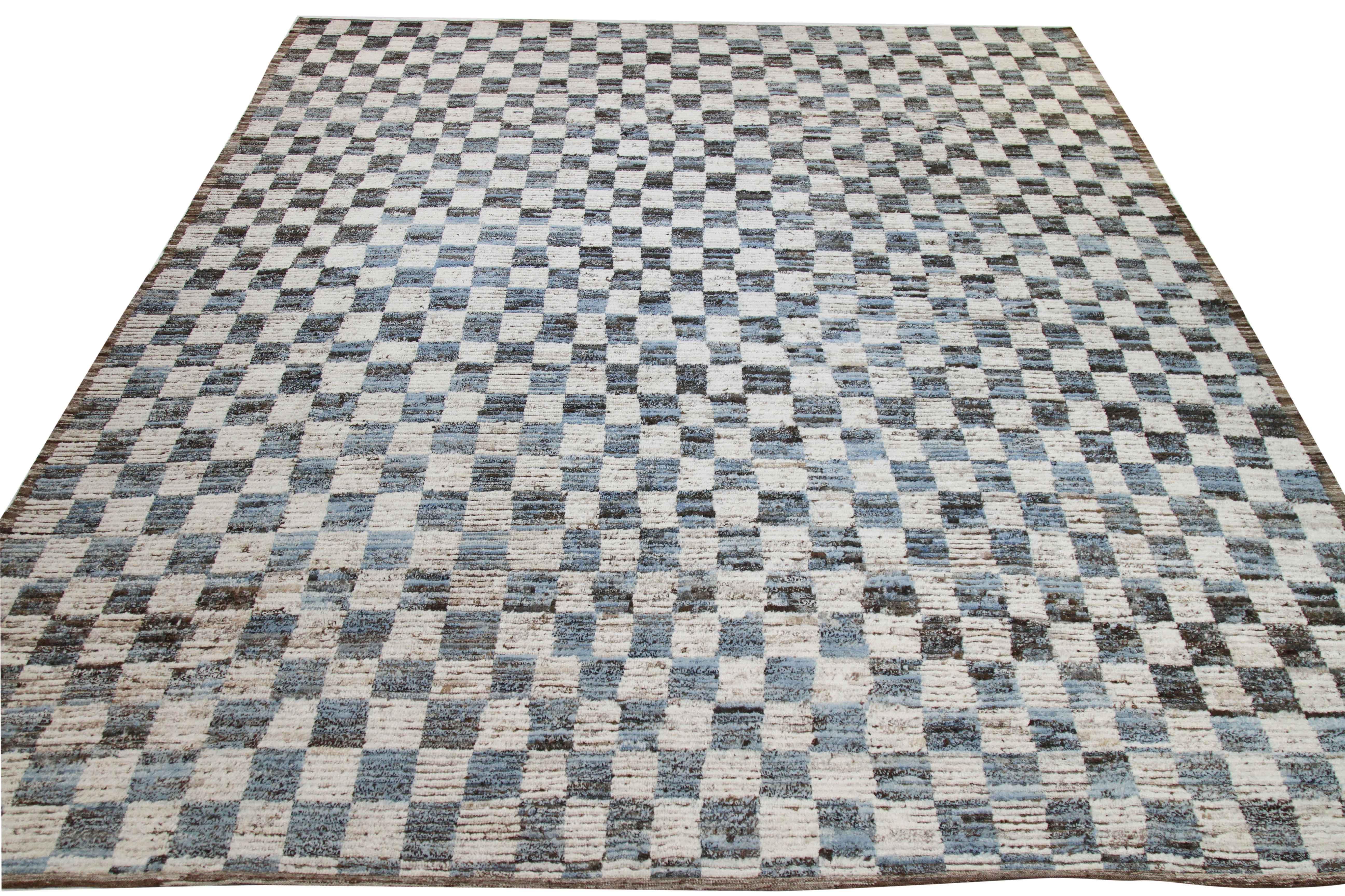 Modern Afghan rug handwoven from the finest sheep’s wool and colored with all-natural vegetable dyes that are safe for humans and pets. It’s a traditional Afghan weaving featuring a Moroccan inspired design highlighted by a brown and blue checkered