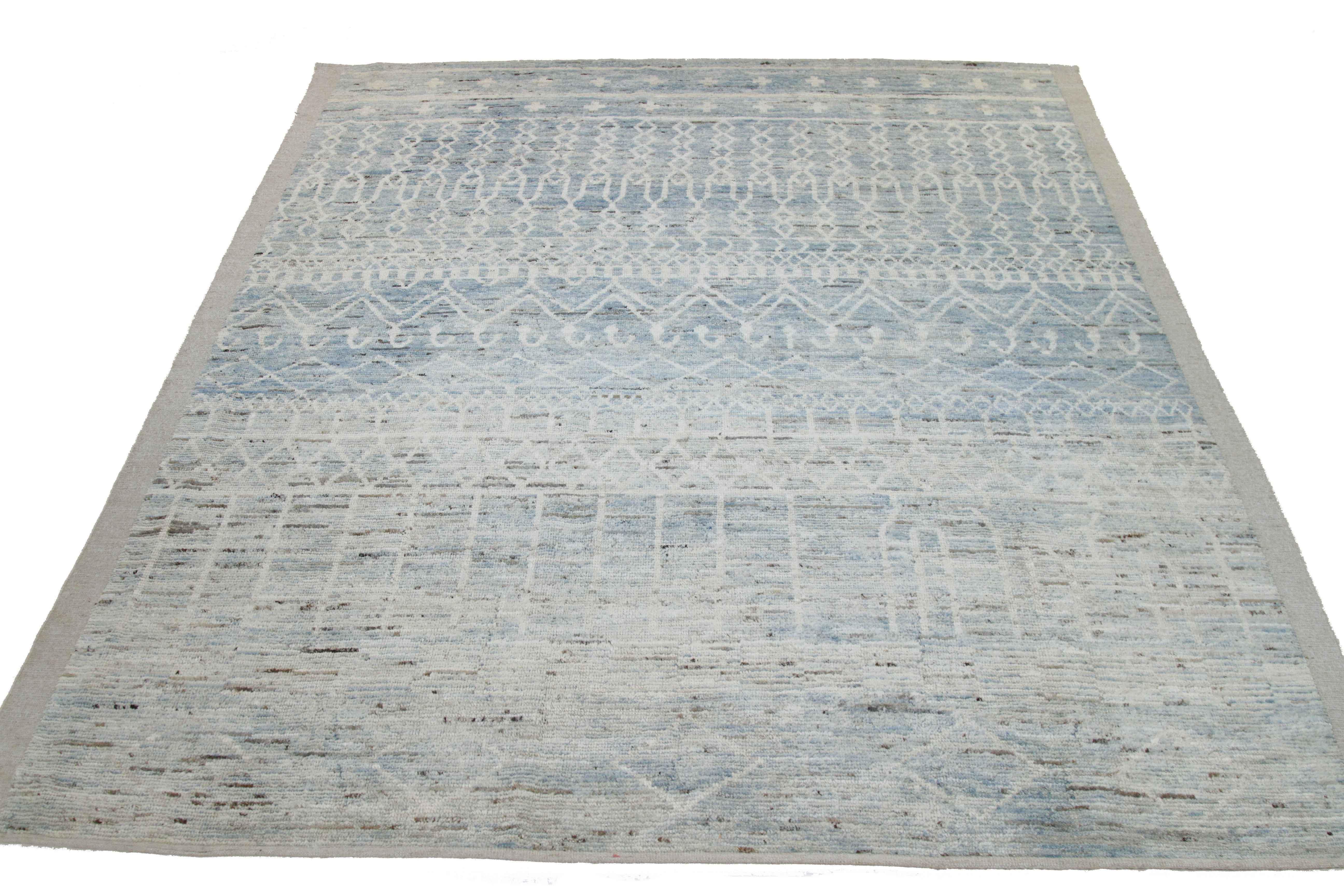 Modern Afghan rug handwoven from the finest sheep’s wool and colored with all-natural vegetable dyes that are safe for humans and pets. It’s a traditional Afghan weaving featuring a Moroccan inspired design highlighted by tribal details in ivory and