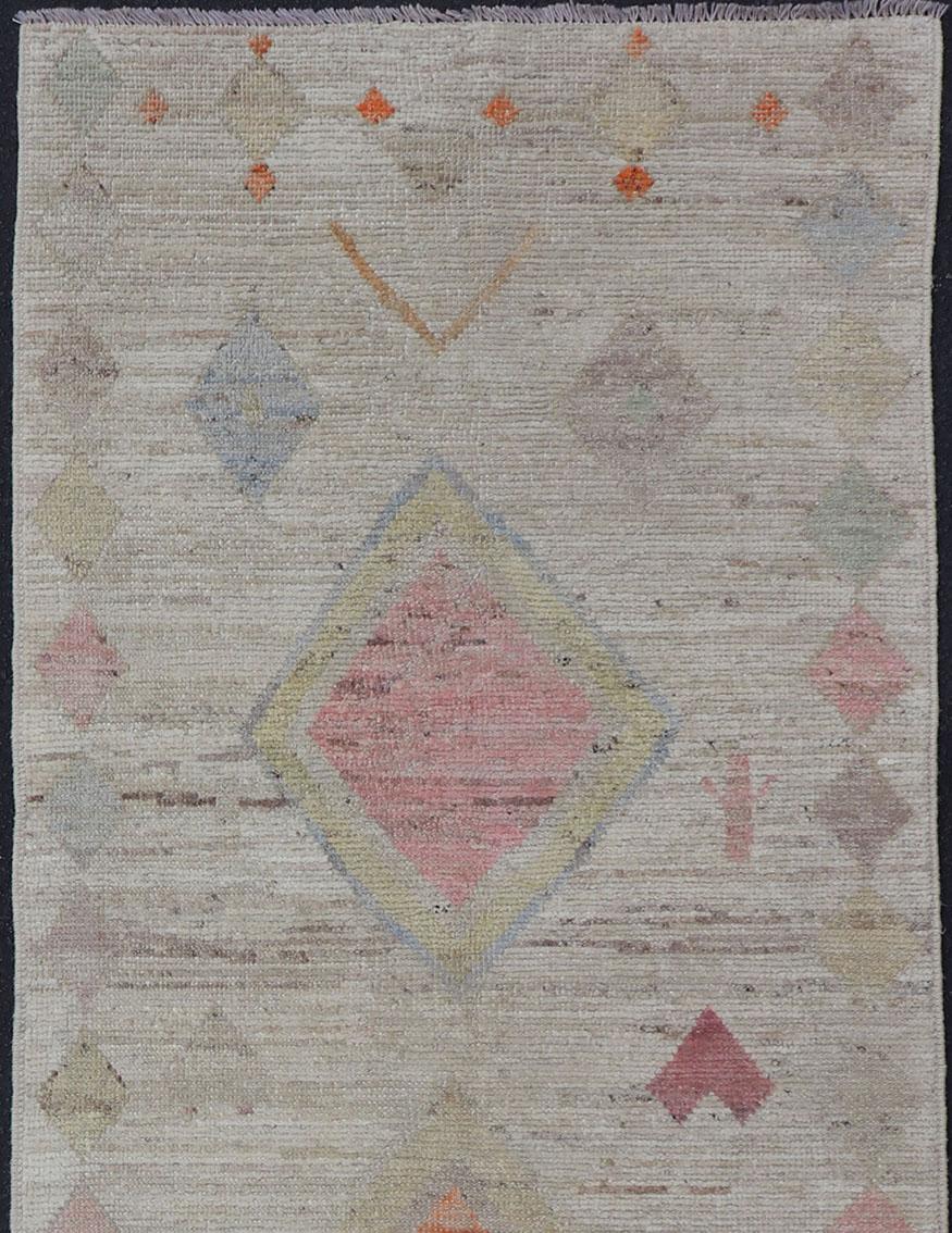 Afghan Tribal designed runner in cream and vivid color palette and all-over flower design, rug AFG-36124, Keivan Woven Arts/ country of origin / type: Afghanistan / Modern

This modern rug features a subdued cream and vivid color palette and an