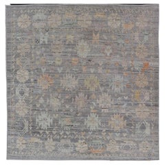 Modern Afghan Tribal Motif Designed Rug in Muted Tones and a Gray Background