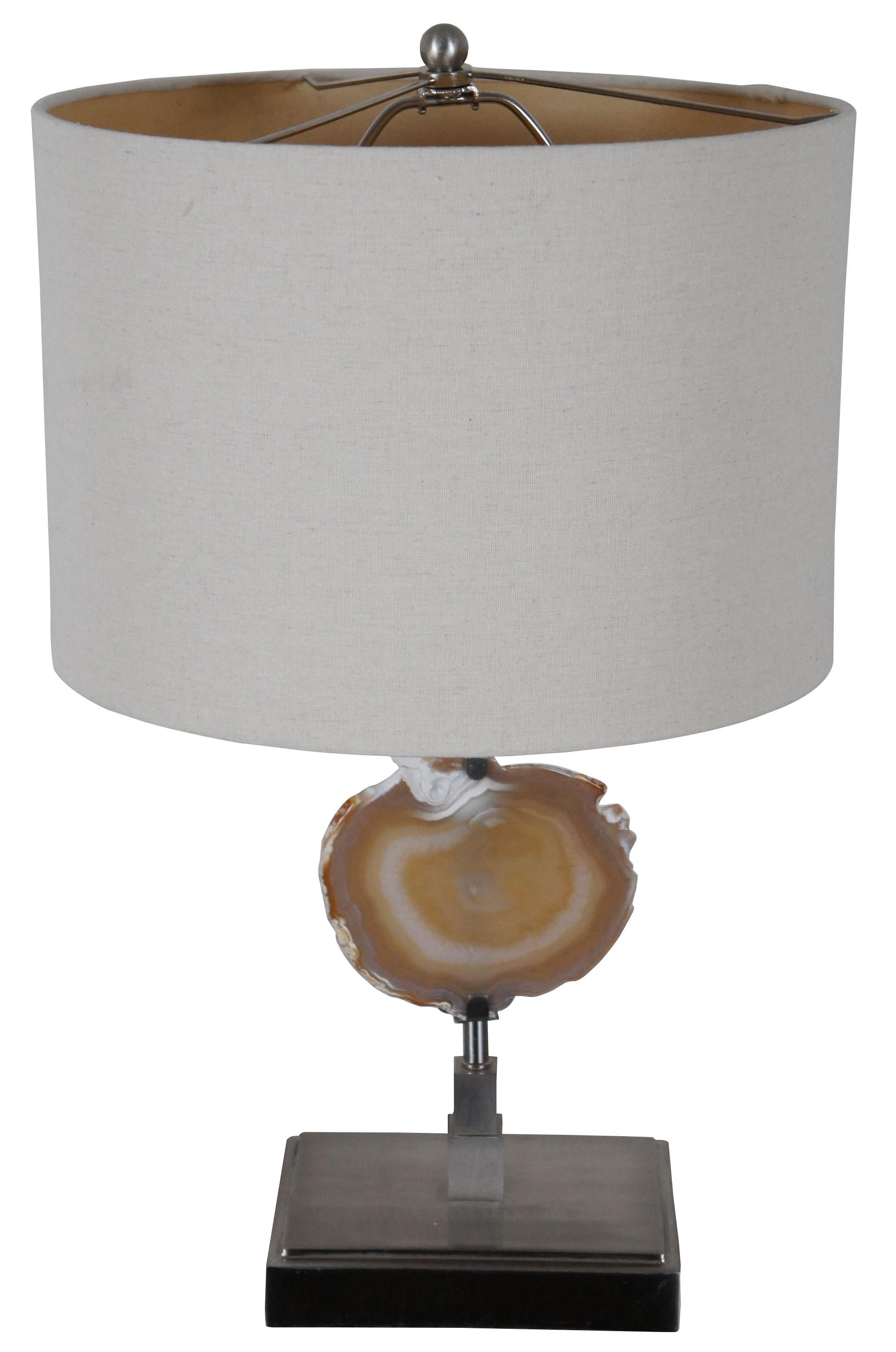 Modern steel table lamp with mounted polished Agate geode specimen and white shade.

Measures: 7” x 5” x 16” / shade - 13” x 9” / Height to Top of Finial – 22” (Width x depth x height).