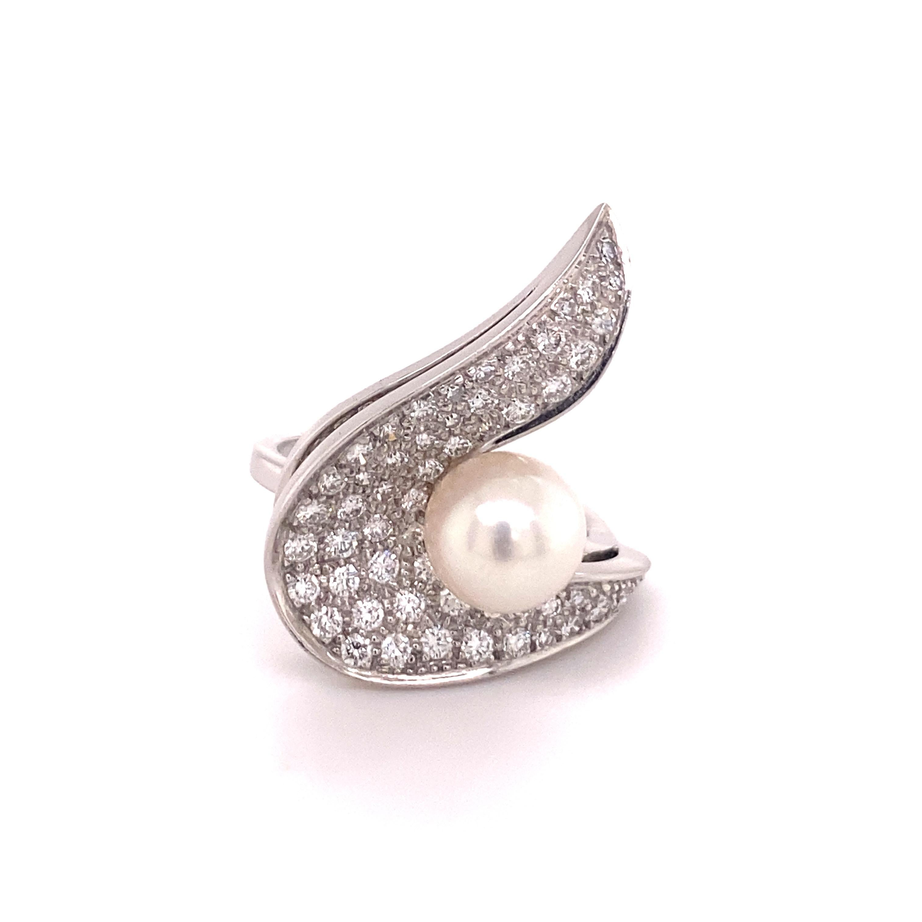Modern akoya cultured pearl and diamond ring with a twist! Handmade manufactured in 18 karat white gold. 

Elegantly curved design with concave and convex elements; pavé-set with 55 brilliant-cut diamonds totalling 1.18 ct of weight. Set with one