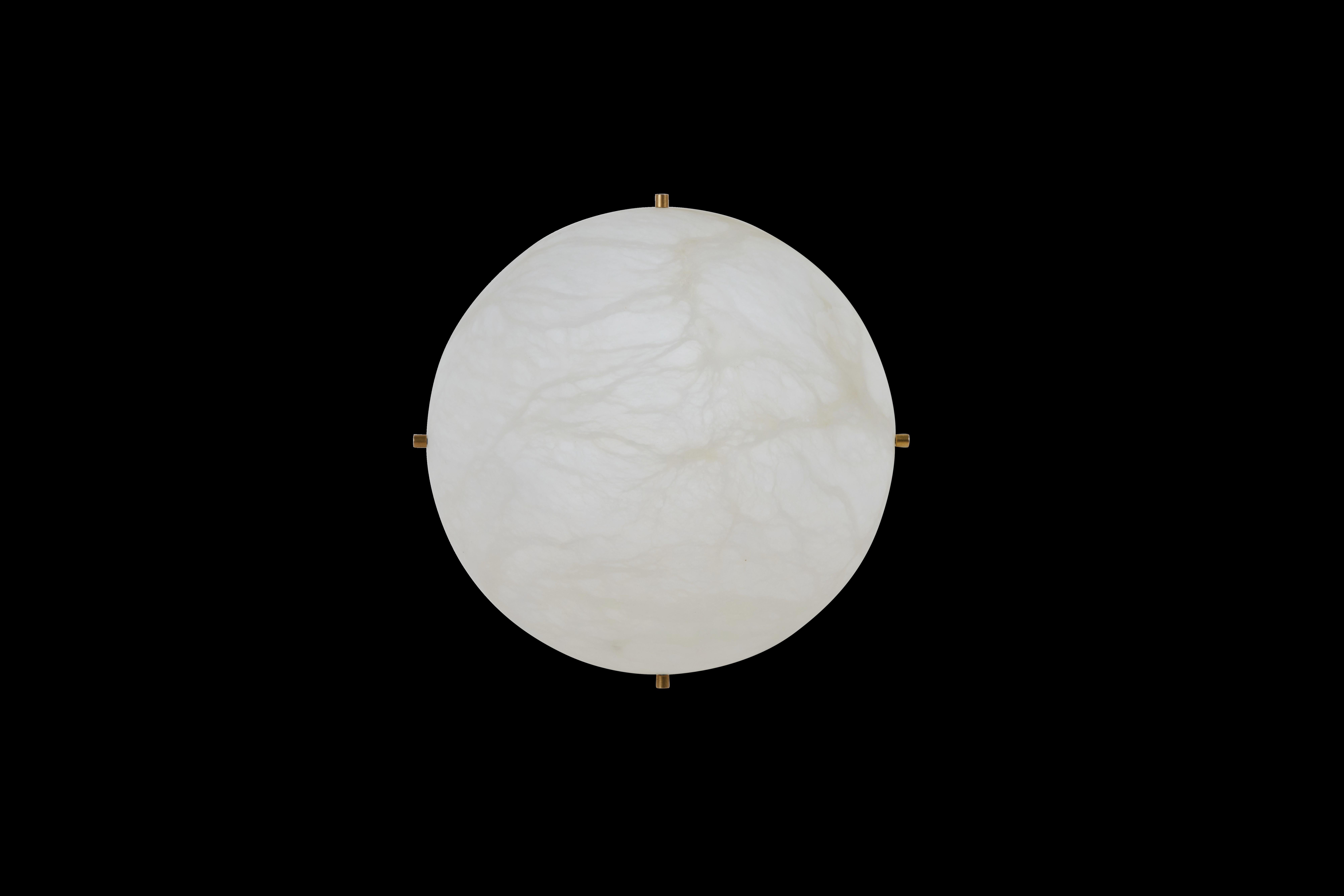 This refined sconce combines genuine alabaster and solid brass accents by French designer Denis de La Mesiere.

The alabaster material, renowned for its exceptional quality, diffuses soft and warm light throughout the room, creating a soothing