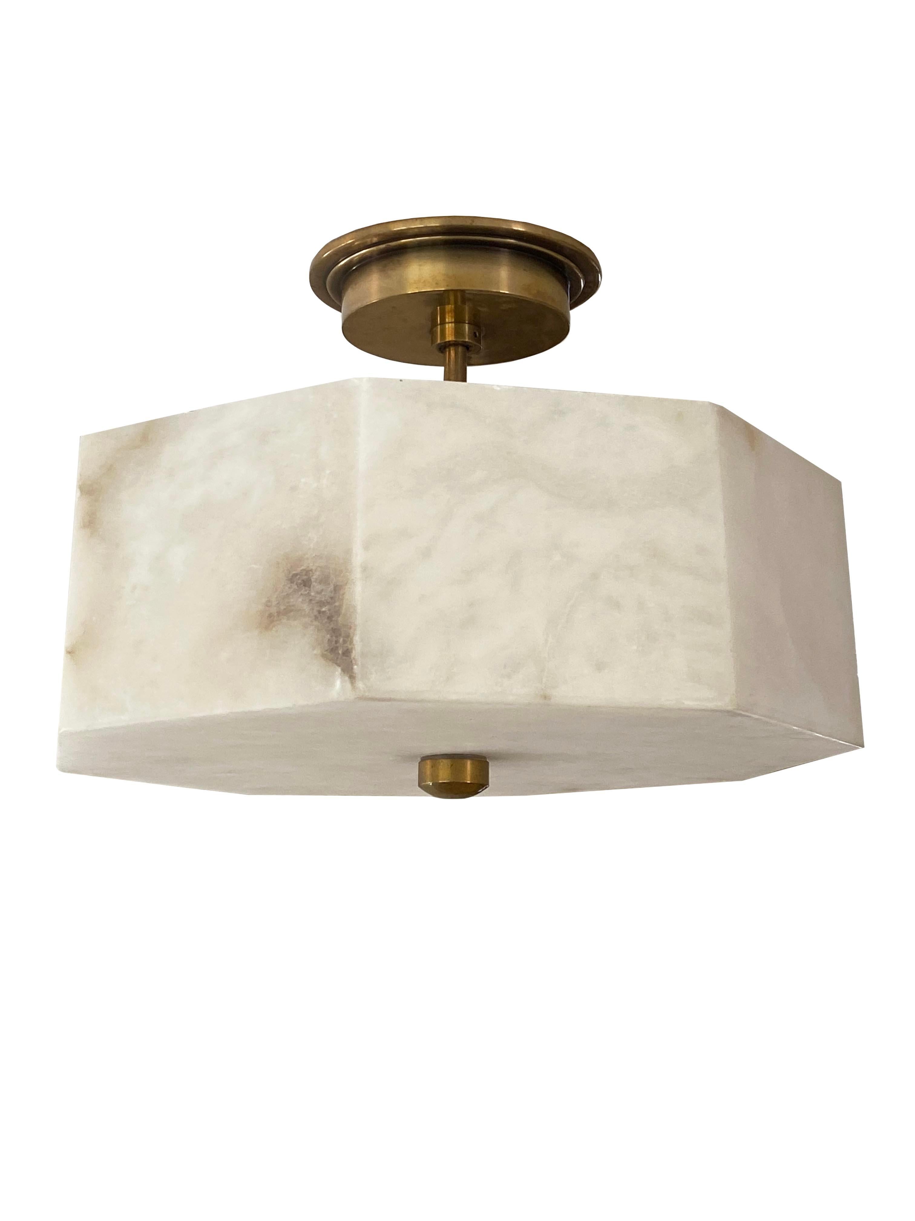 Elevate your interior with the understated elegance of this alabaster and brass flush mount ceiling light. Featuring a beautifully sculpted octagonal alabaster shade, this fixture exudes a warm, diffused glow that enhances any room with a sense of