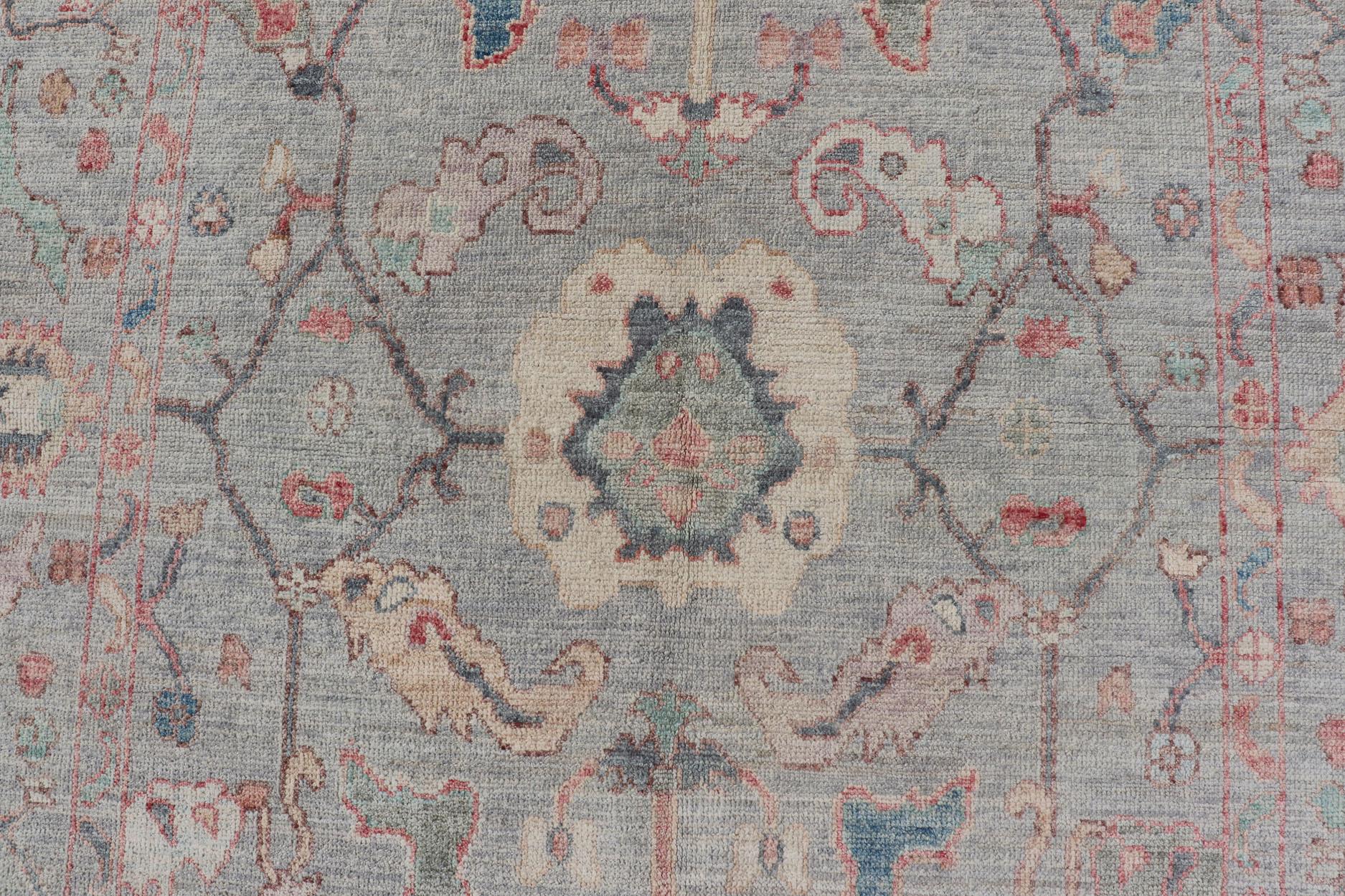 Modern All-over floral oushak with a light blue-gray background and multi-colors. Keivan Woven Arts; rug AWR-5109 Country of origin: Afghanistan Type: Oushak Design: Floral, All-Over, Abstract Floral

Measures: 5'0 x 7'6

This modern floral