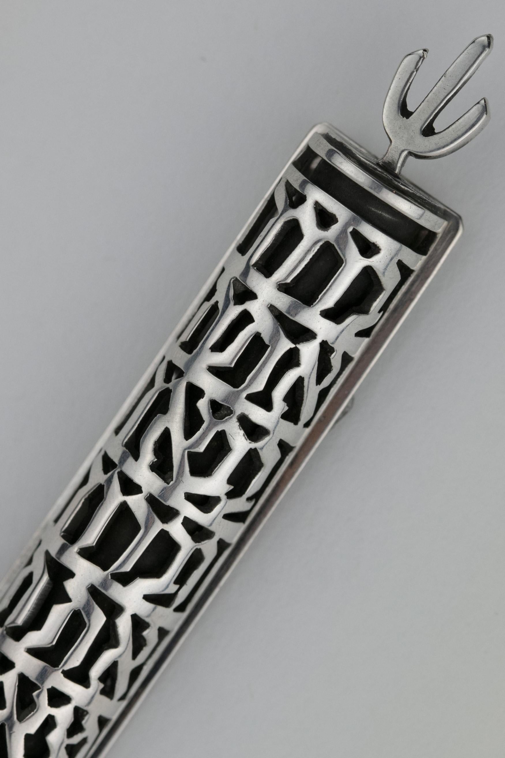 Modern silver Mezuzah by Ludwig Yehuda Wolpert, New York, USA, circa 1960.
Cut with lattice work, spelling out Hebrew blessings: 