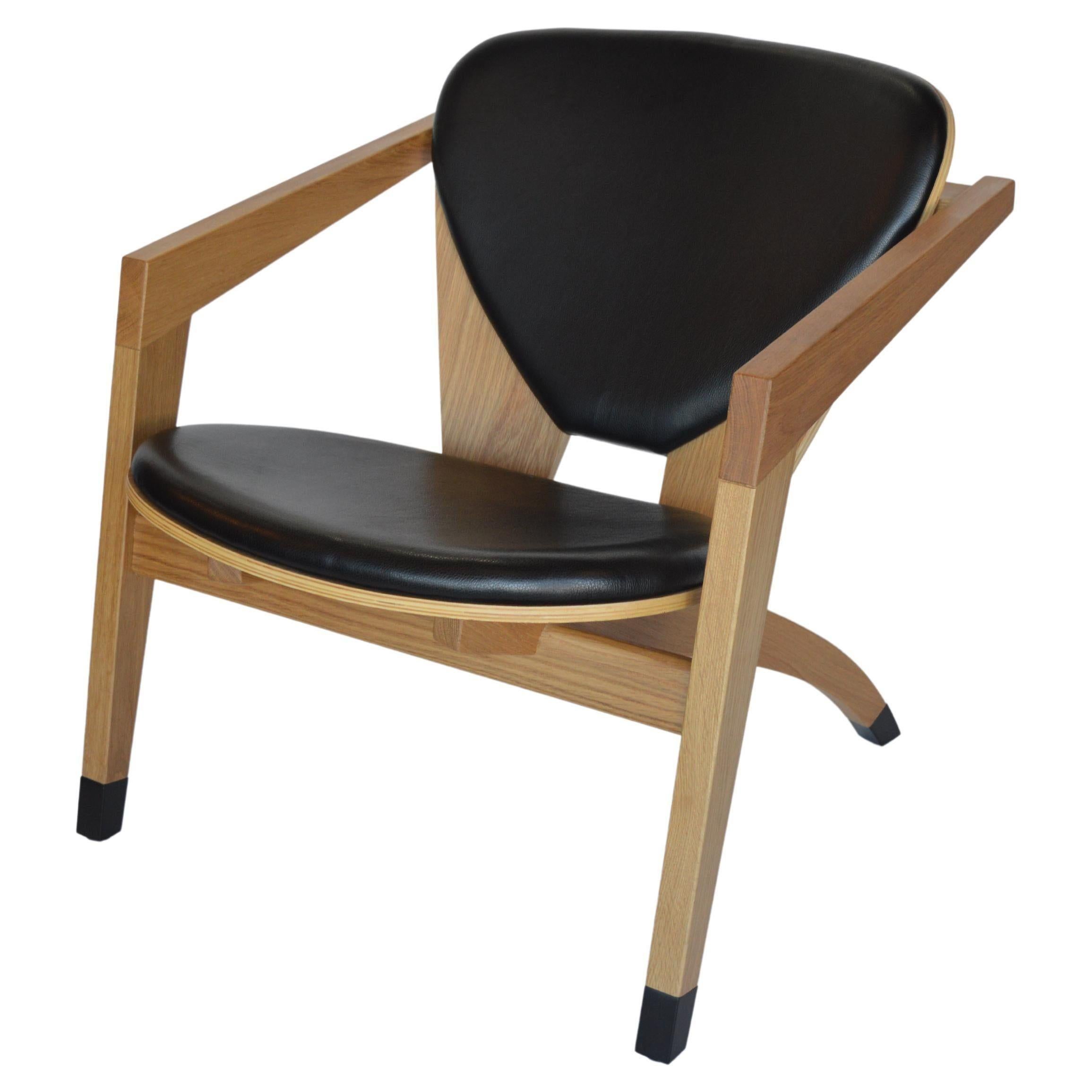 Modern American wood armchairs with leather upholstery. USA, 21st Century.