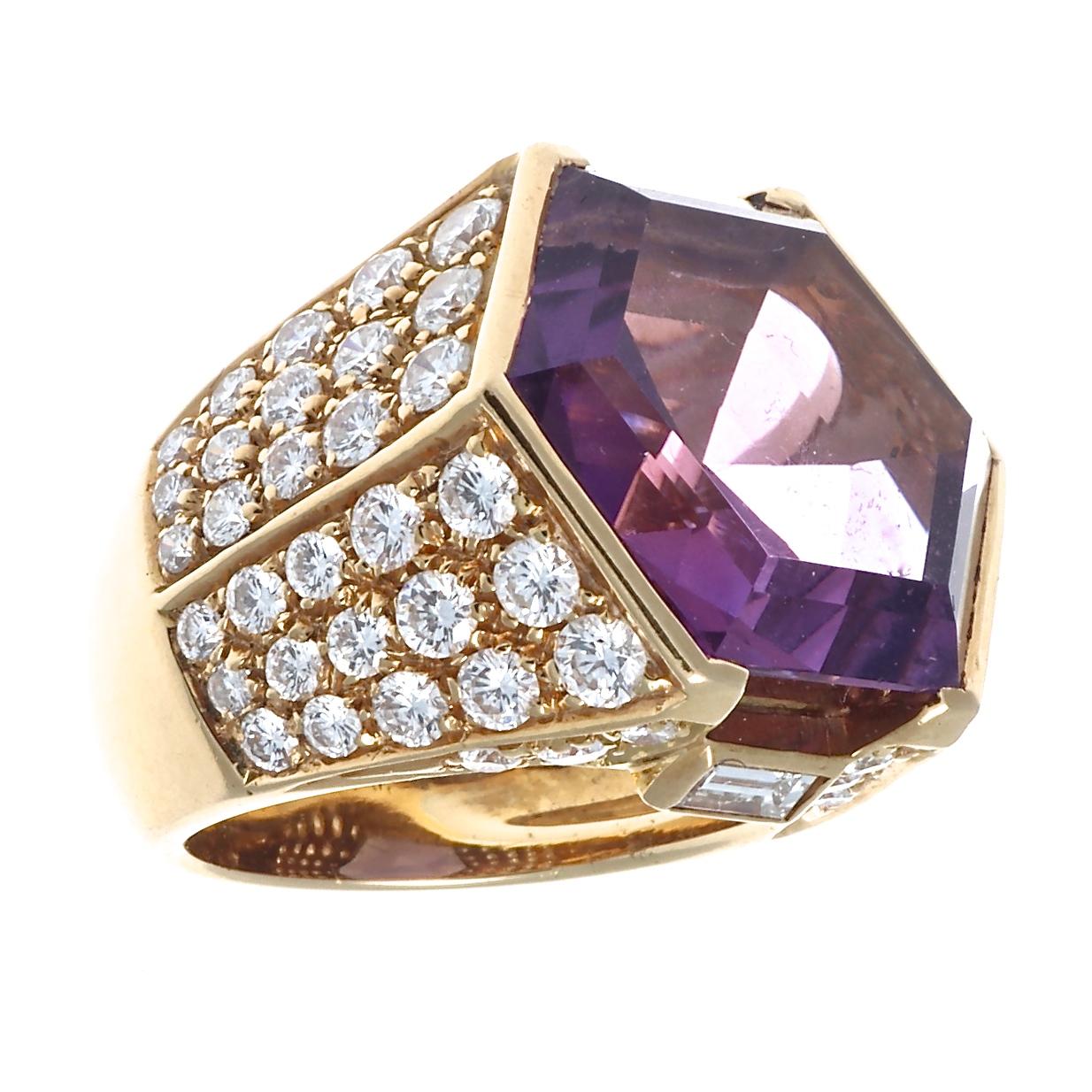 Captivating 1970's amethyst diamond ring. Featuring a beautifully faceted hexagonal amethyst weighing approximately 18 carats. There are a total of 72 round brilliant diamonds and 2 baguette cut diamonds on the ring shank, with a total approximate