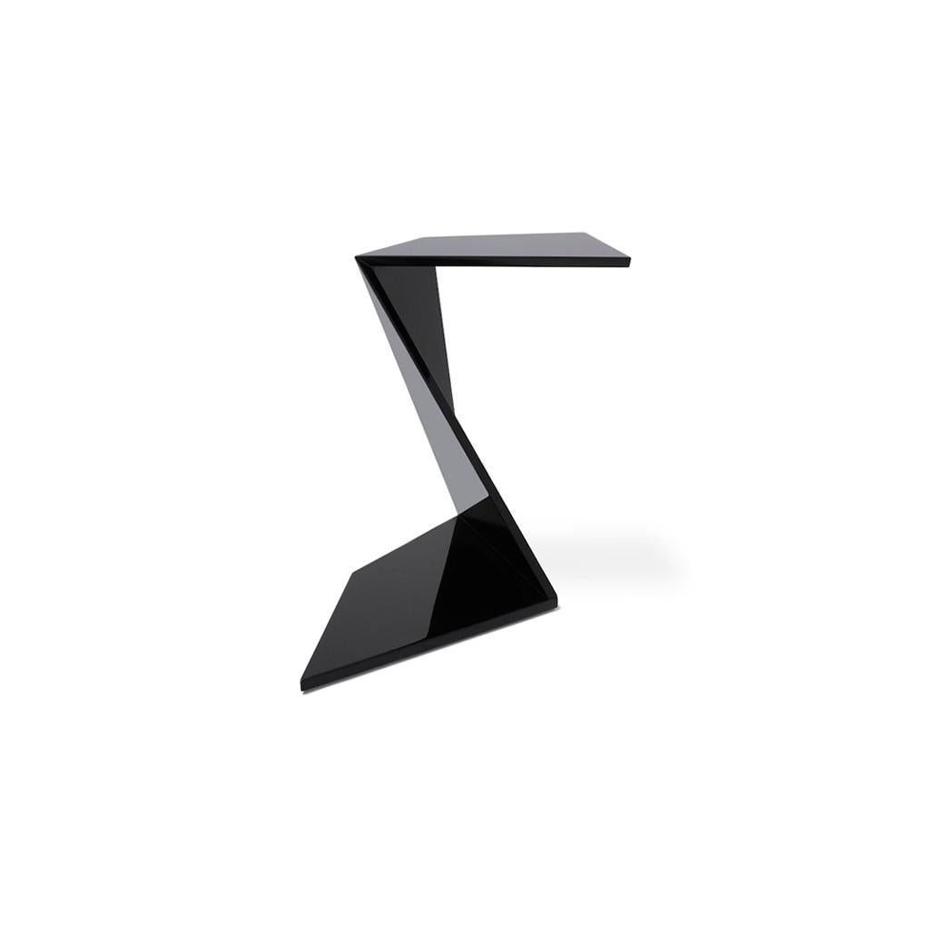 Handcrafted in wood, the minimalist and C-shaped flow side table is available in a variety of lacquered finishes. The form symbolizes power, simplicity and elegance at the same time. The design demonstrates the dynamics of equilibrium, gravity, and