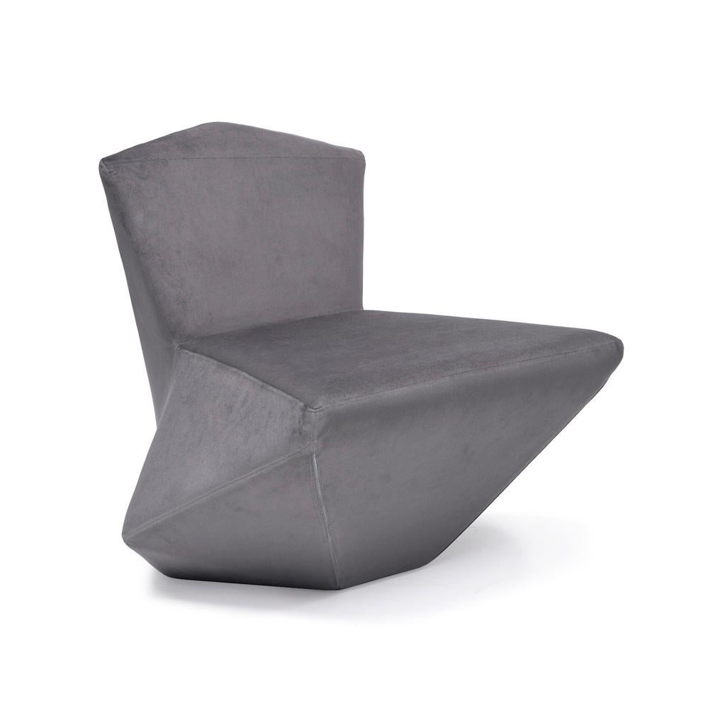 Handcrafted lounge sofa borrows sharp-edged architectural elements yet it is sculpted to give soft touch in order to create sensational opposite effects. The futuristic and postmodern looking armchair embraces the leaf - hand shape chair with