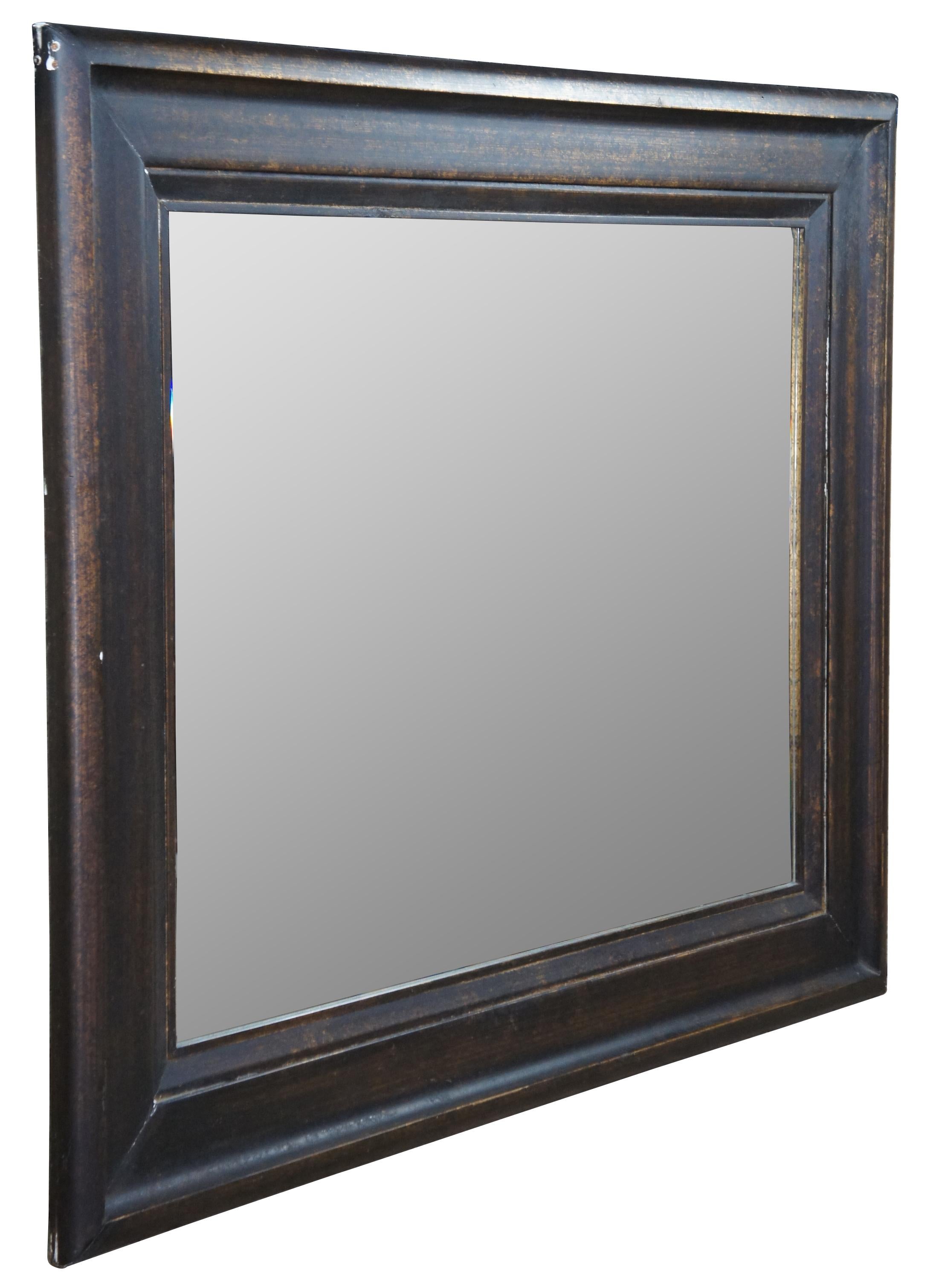 Oversized modern wall mirror. Great for user over a mantel/ along a wall. Black and gold mottled finish with beveled glass.

Measures: 50