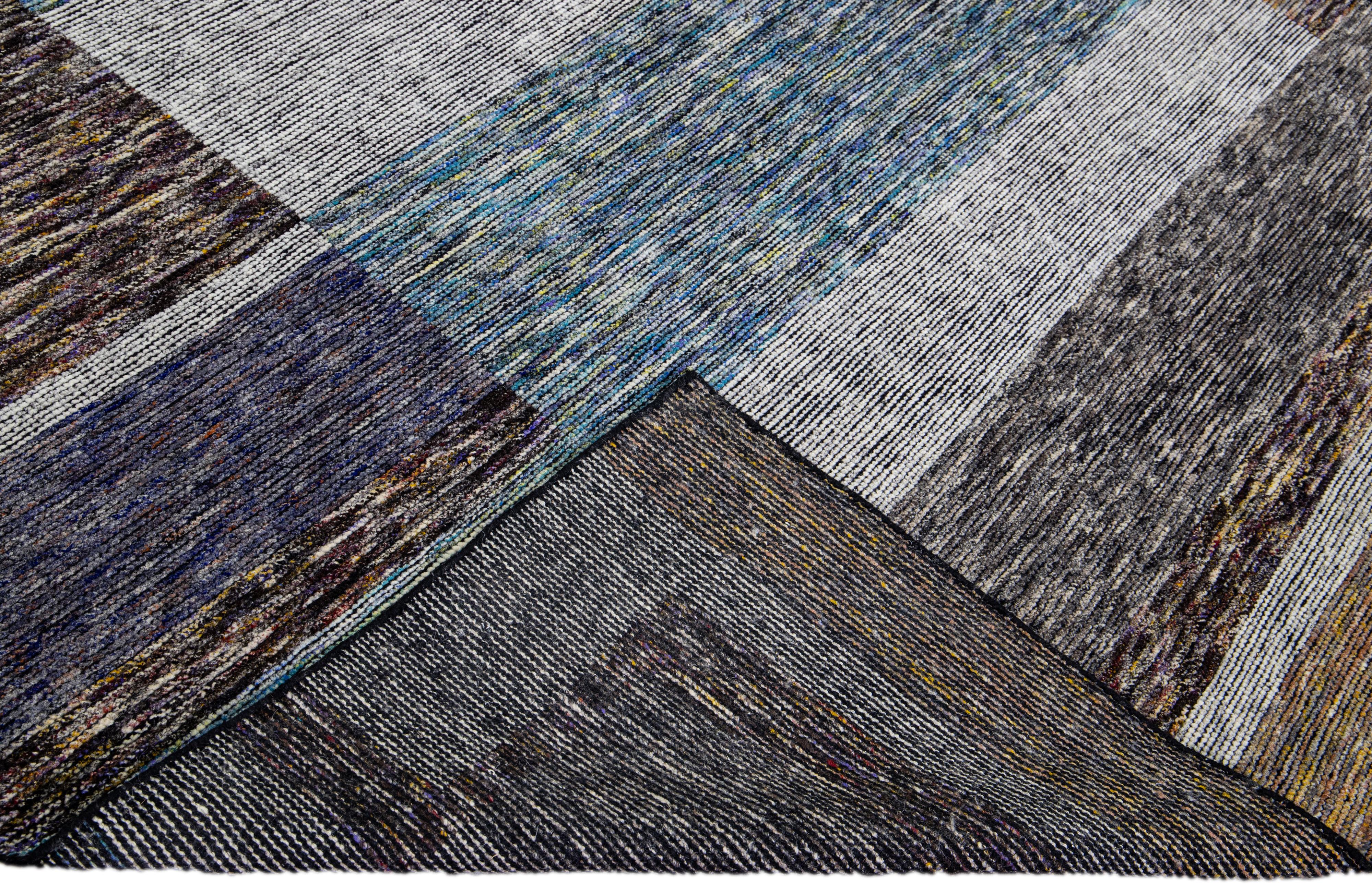 Beautiful modern Apadana's Safi Collection hand-knotted wool rug with an earthy colors field. This Modern rug has blue, gray, and brown accents a gorgeous layout Abstract design.

This rug measures: 9'3