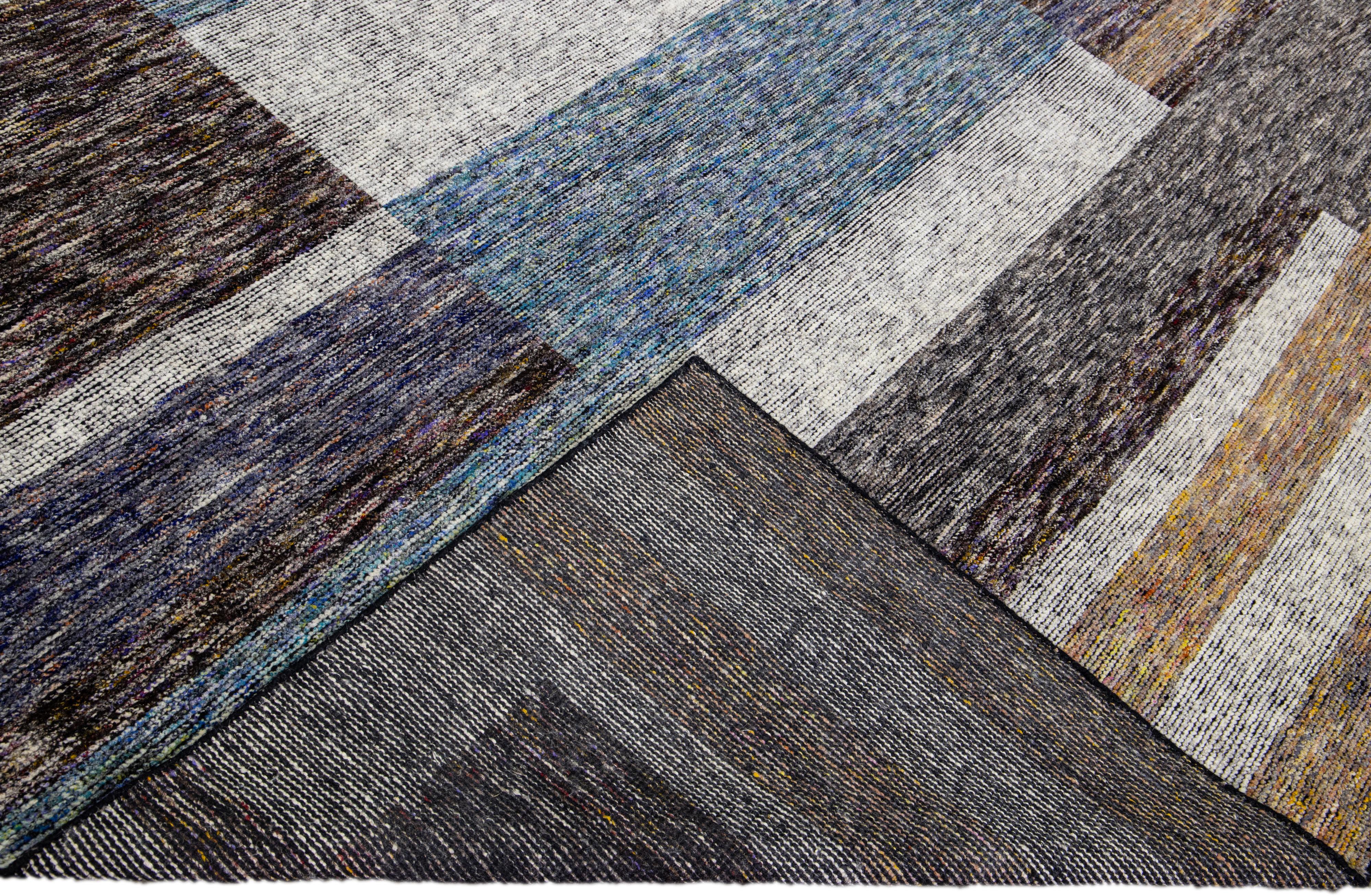 Wunderschöner moderner handgeknüpfter Wollteppich aus der Safi Collection von Apadana mit einem erdigen Farbfeld. Dieser moderne Teppich hat blaue, graue und braune Akzente ein wunderschönes Layout abstraktes Design.

Dieser Teppich misst: 9'3