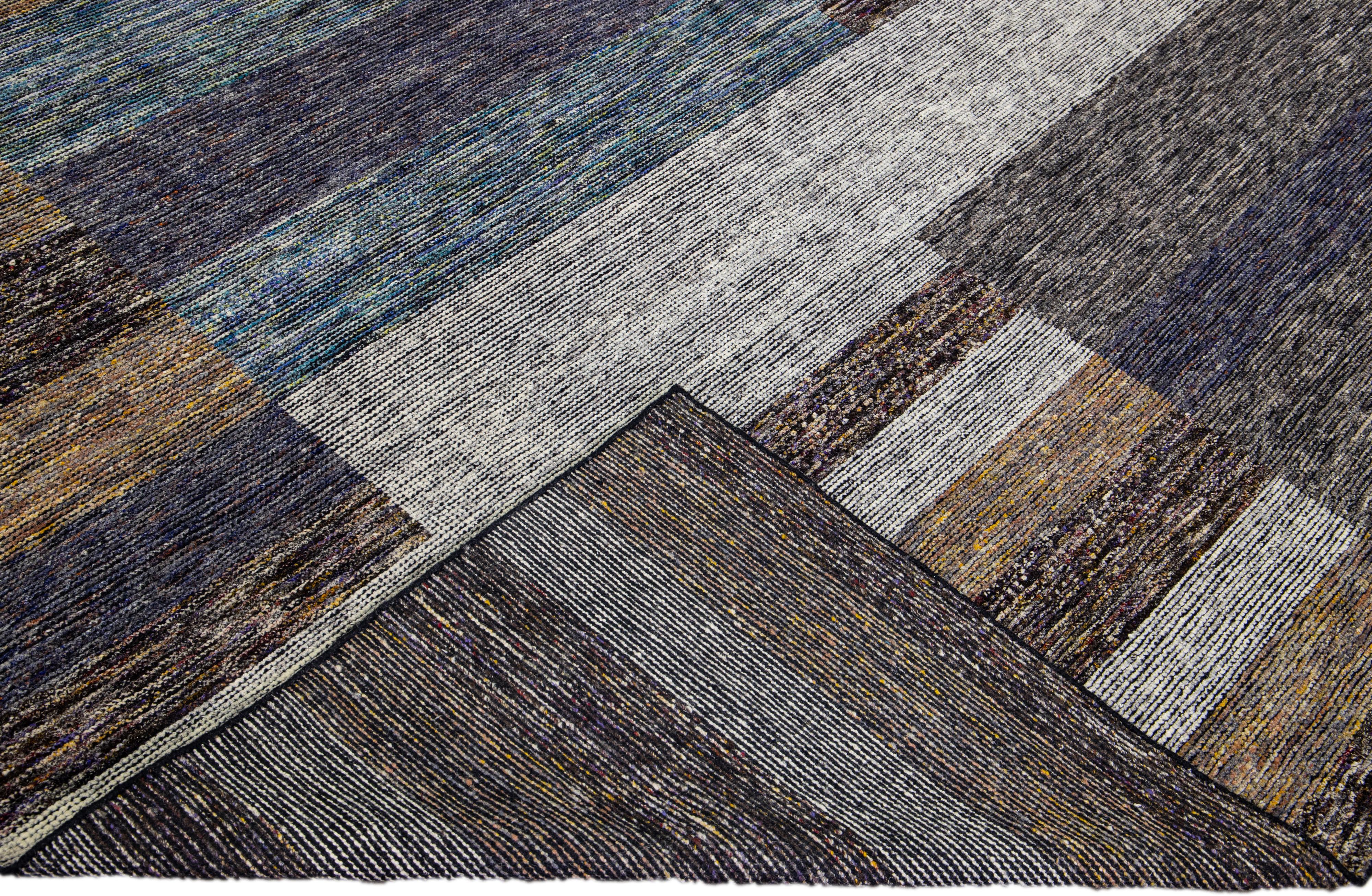 Beautiful modern Apadana's Safi Collection hand-knotted wool rug with an earthy colors field. This Modern rug has blue, gray, and brown accents a gorgeous layout Abstract design.

This rug measures: 10'2