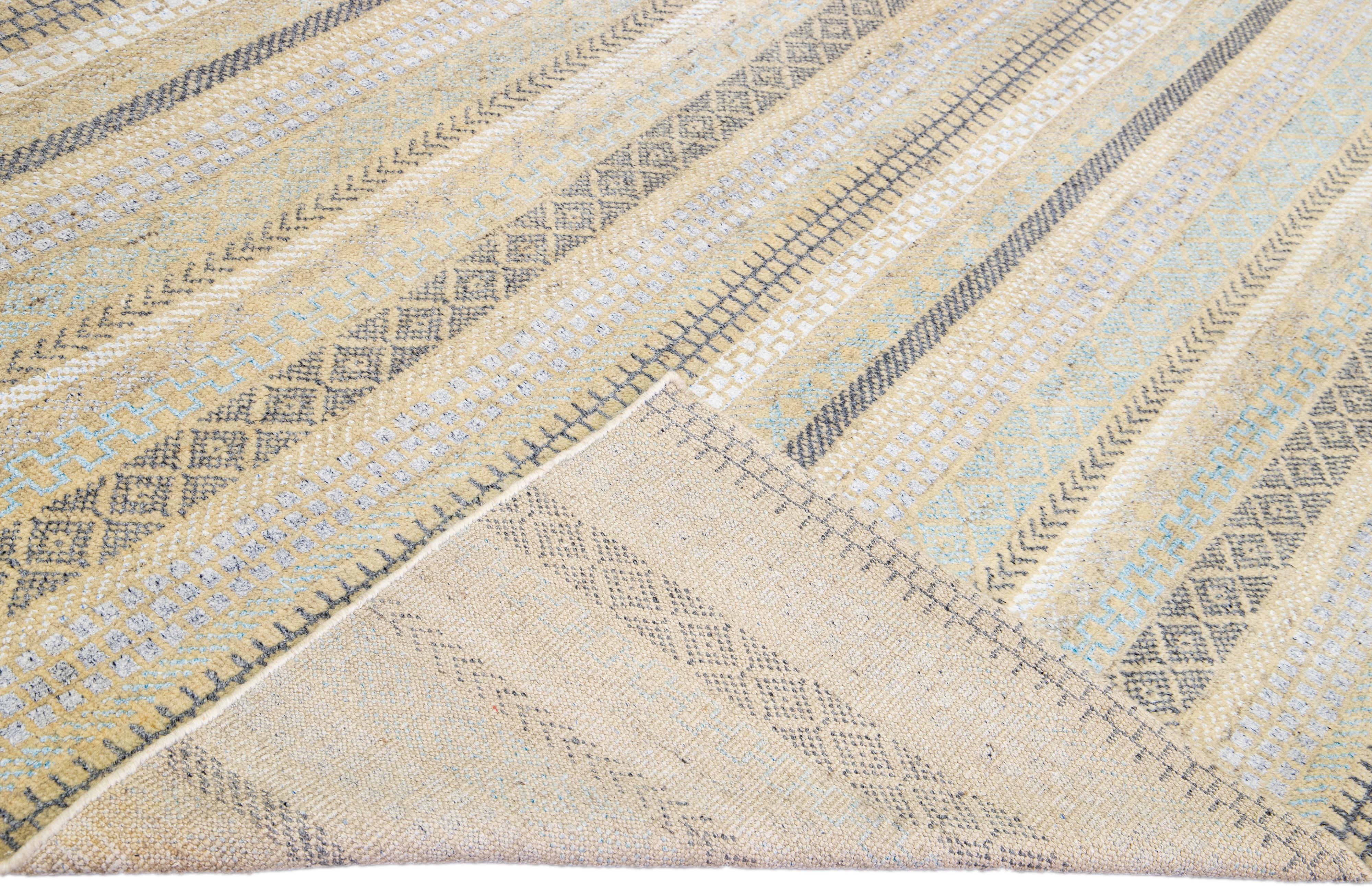 Beautiful modern Apadana's Safi Collection hand-knotted wool rug with a beige color field. This Modern rug has blue, ivory, and gray accents in a gorgeous all-over geometric design.

This rug measures: 9'9