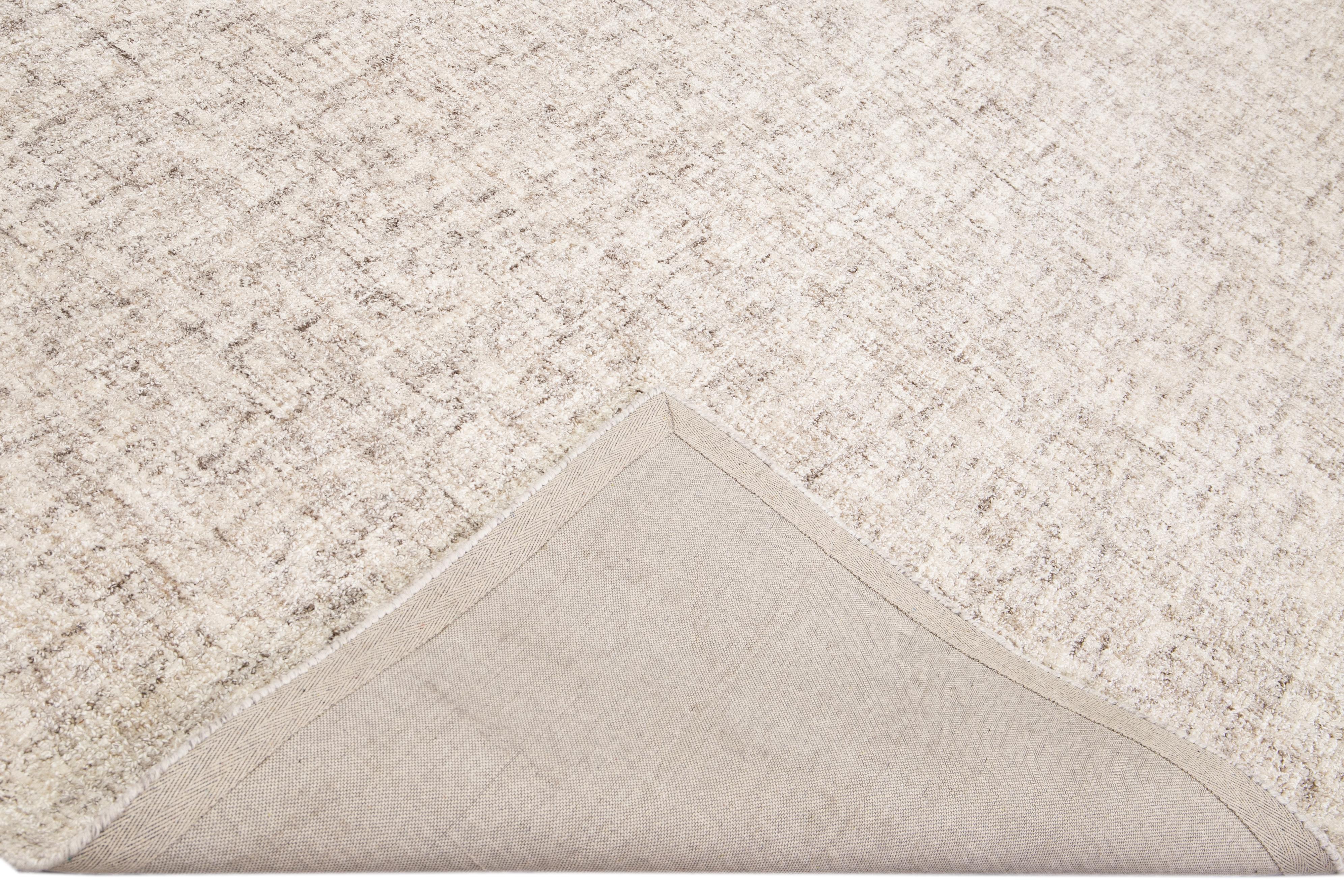 Beautiful Apadanas' collection hand tufted Indian natural wool rug with the beige and brown field. This Westport collection rug has an all-over solid strie design.

This rug measures: 9' x 12'.

Custom colors and sizes are available upon