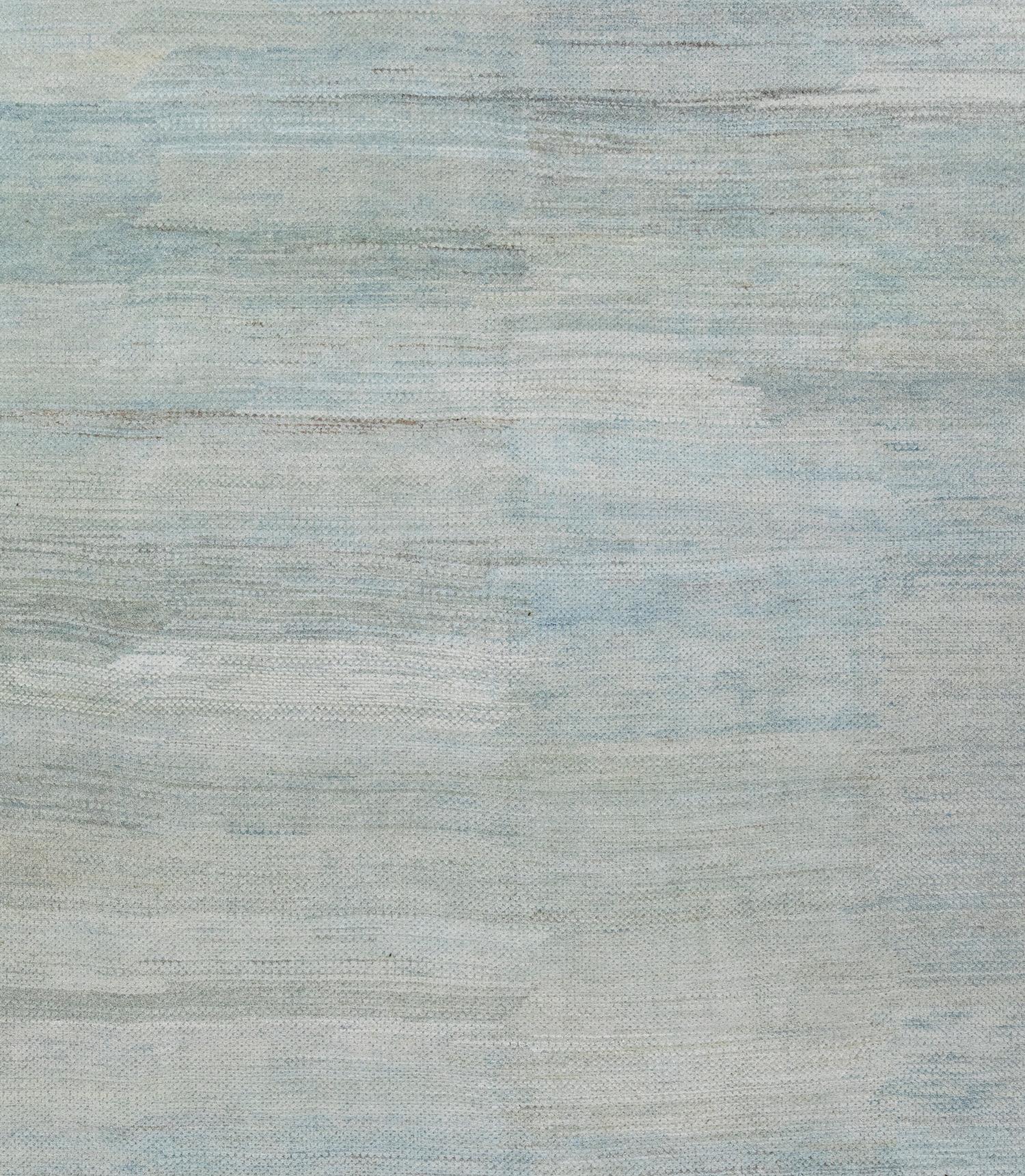 This is a beautiful modern rug featuring a blue/green abrash paint brush style. It has a great deal of texture as it has a subtle relief design throughout. This piece is extremely versatile making it suitable for both period and contemporary
