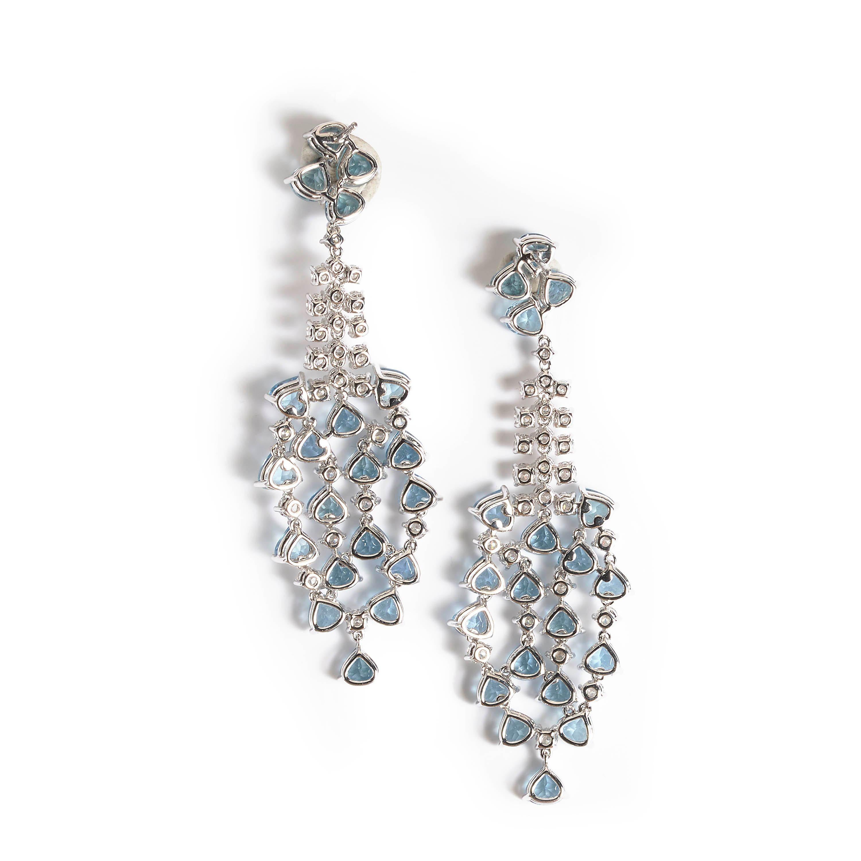 A pair of modern fancy drop earrings, consisting of two pear-shaped aquamarine and round brilliant-cut diamond pendants, suspended by a cluster of aquamarines to the top, claw set and mounted in 18ct white gold, with posts and butterfly