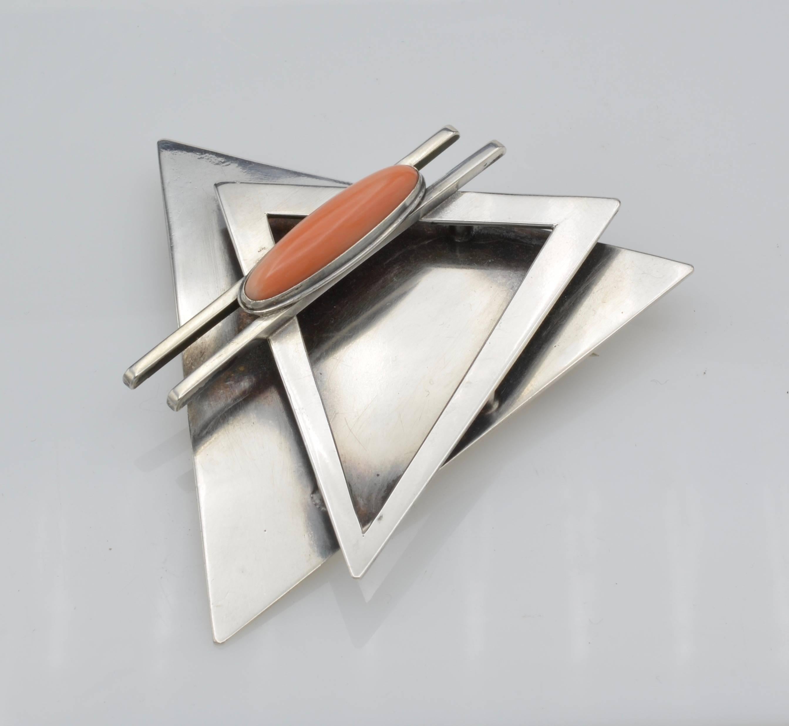 1960 Architectural modern silver and coral, two triangles superposed with the coral cabochon, from an estate bay area Artist studio from the 
Architectural piece with a spot of color with the cabochon coral. The brooch can easily be transform to a