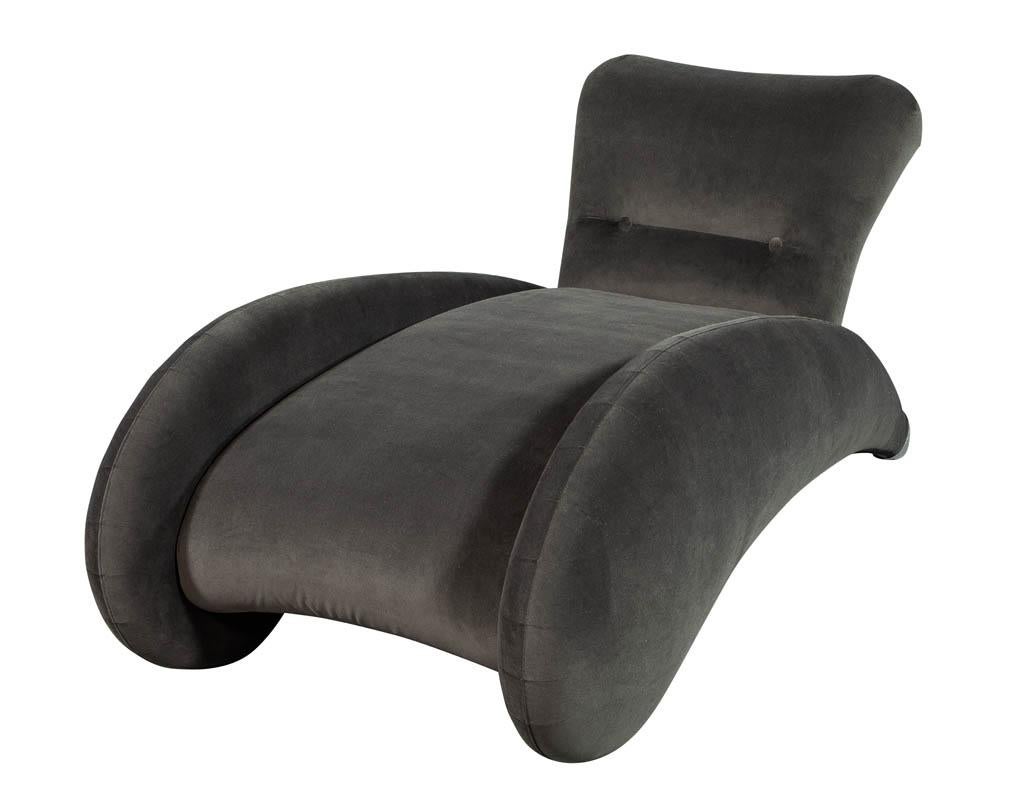 This modern Art Deco inspired chaise lounge has been fully restored. Covered in a grey velvet fabric, it sits upon pointed rear feet with large silver metal tips. A truly unique piece perfect for a daring home.

Price includes complimentary curb