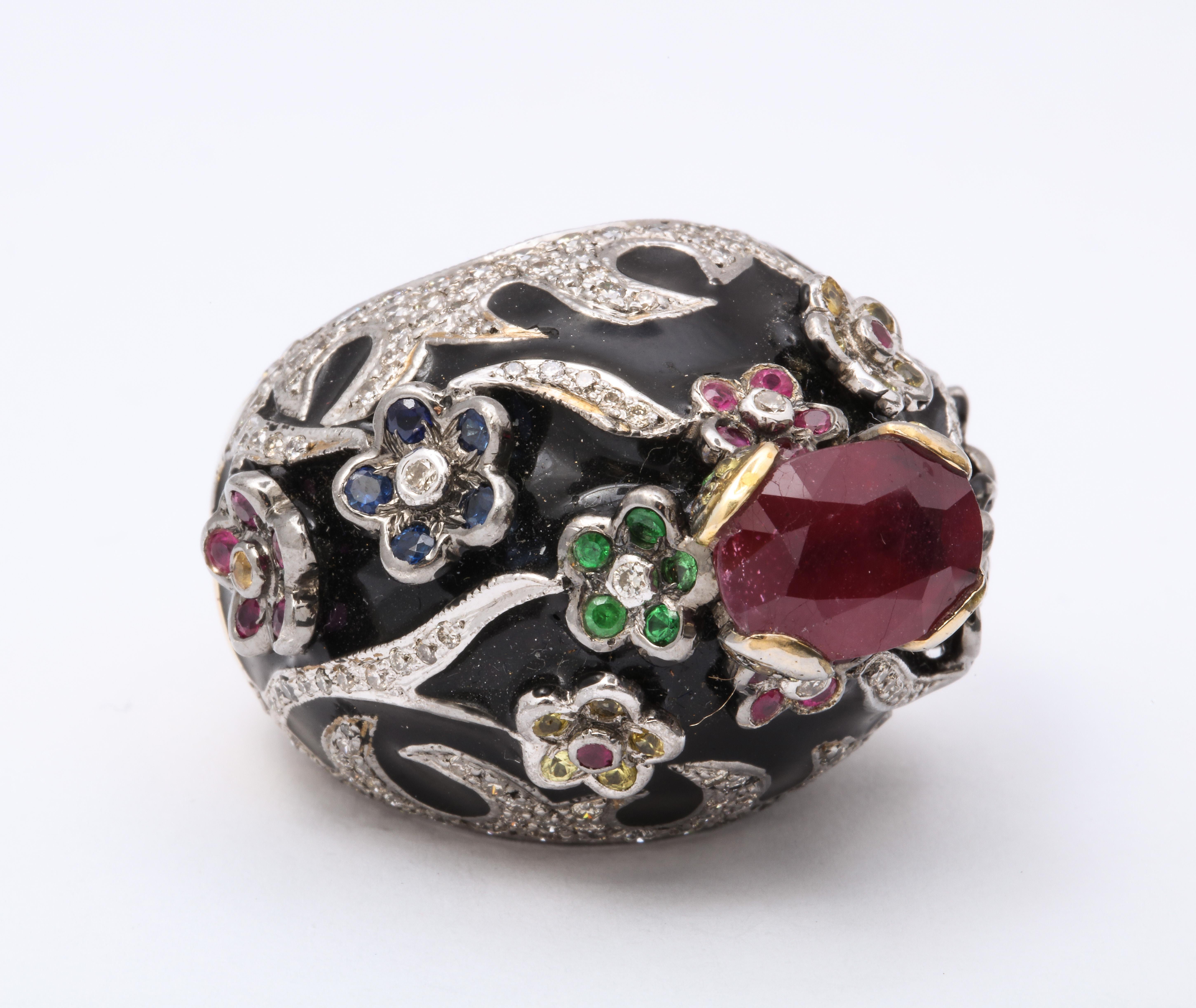 Modern  Runway black enamel ring in sterling with gold overlay.  137 full cut diamonds @ 2.0 carats tw as well as emeralds, sapphires, citrine rounds.  Oval center ruby @ 3.0 carats. Size 8 1/2.   

Materials:
Black enamel
Sterling
Gold