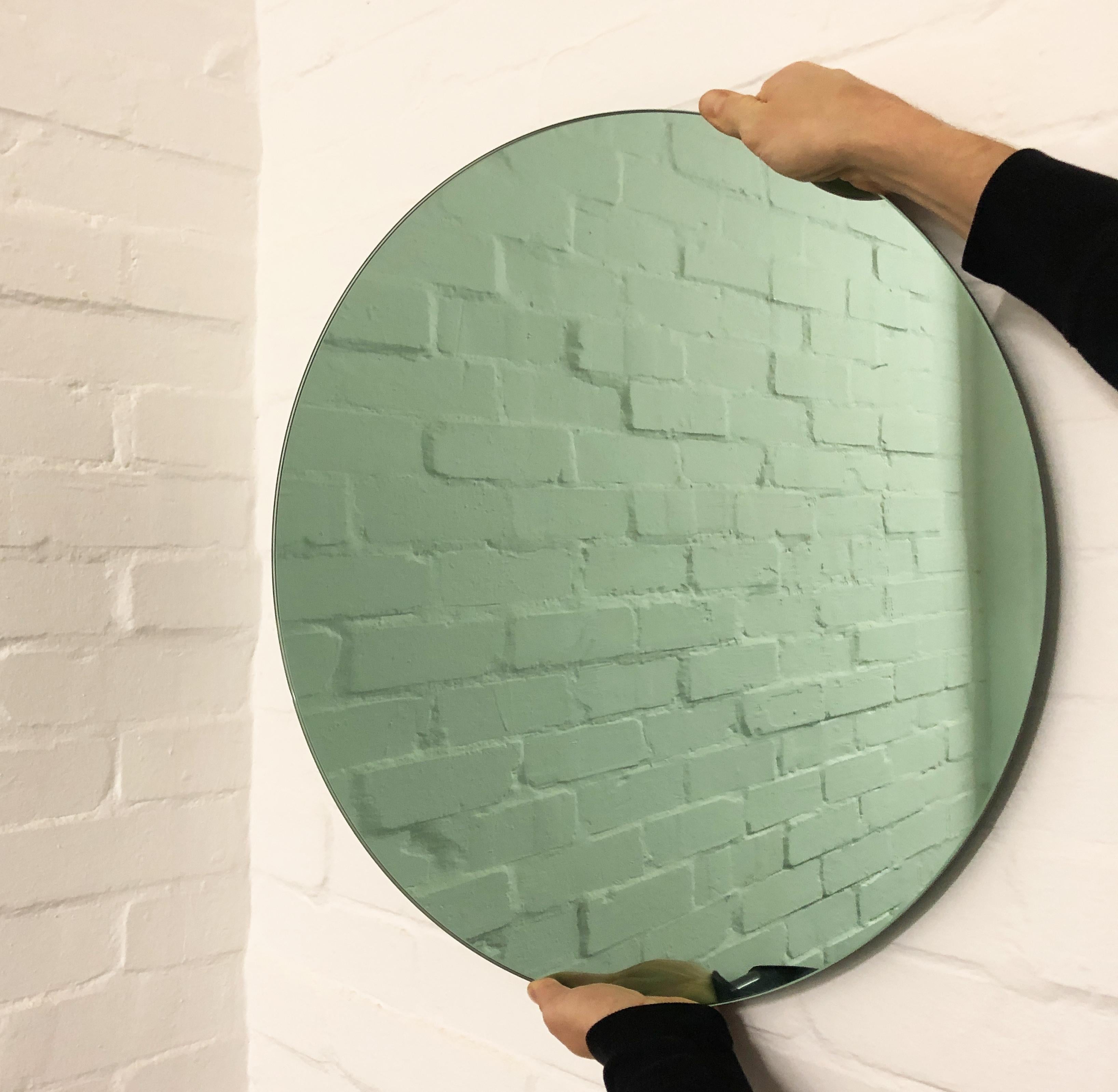 Charming and minimalist green tinted round frameless mirror with a floating effect. Quality design that ensures the mirror sits perfectly parallel to the wall. Designed and made in London, UK. This mirror is fully customizable.

Fitted with