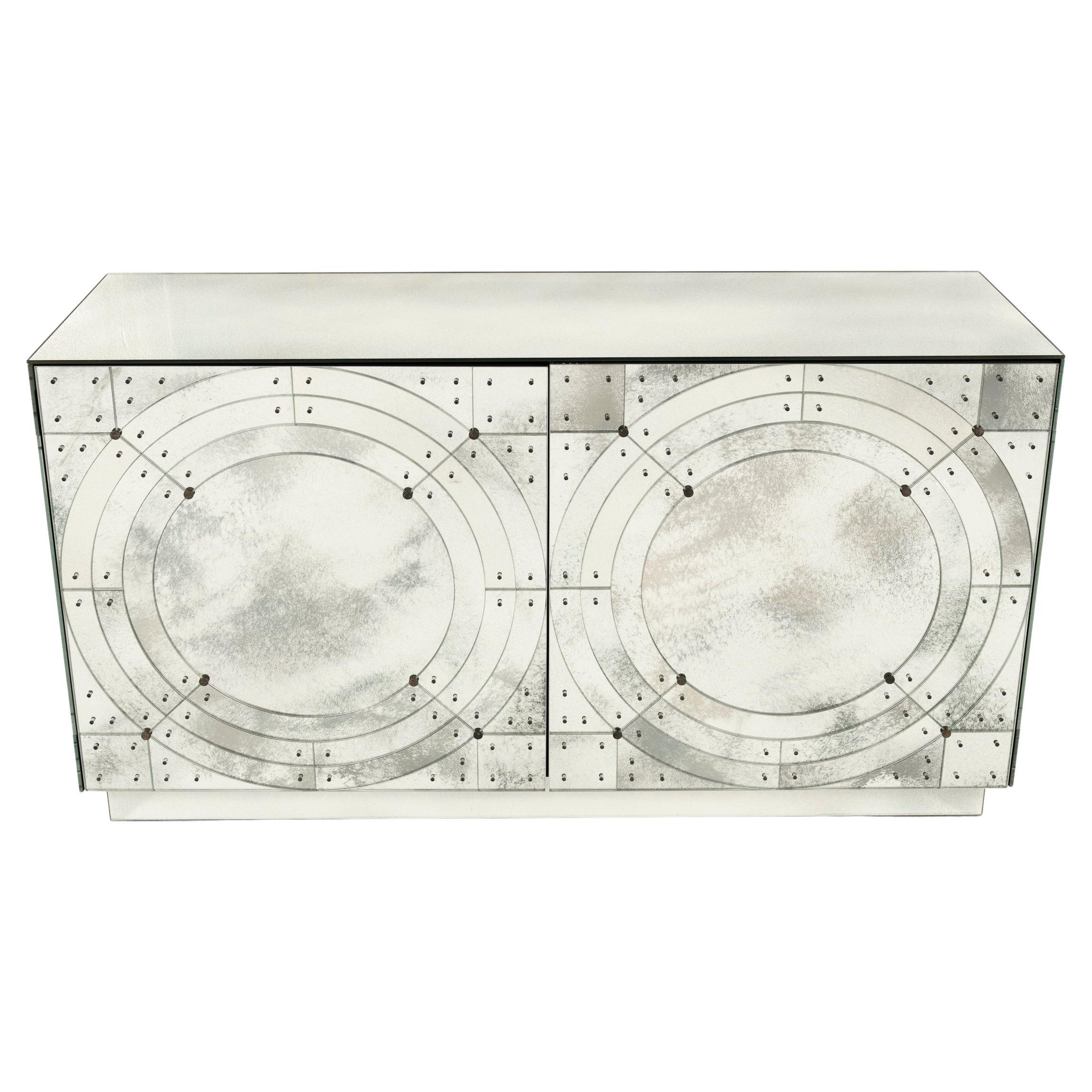 Gorgeous statement cabinet, this Lorin Marsh Orbital Credenza is fitted with  2 doors, 1 drawer and an adjustable shelf behind each door, which are made of wood and have black matte lacquered finish. Exterior is made of antiqued mirror and antiqued