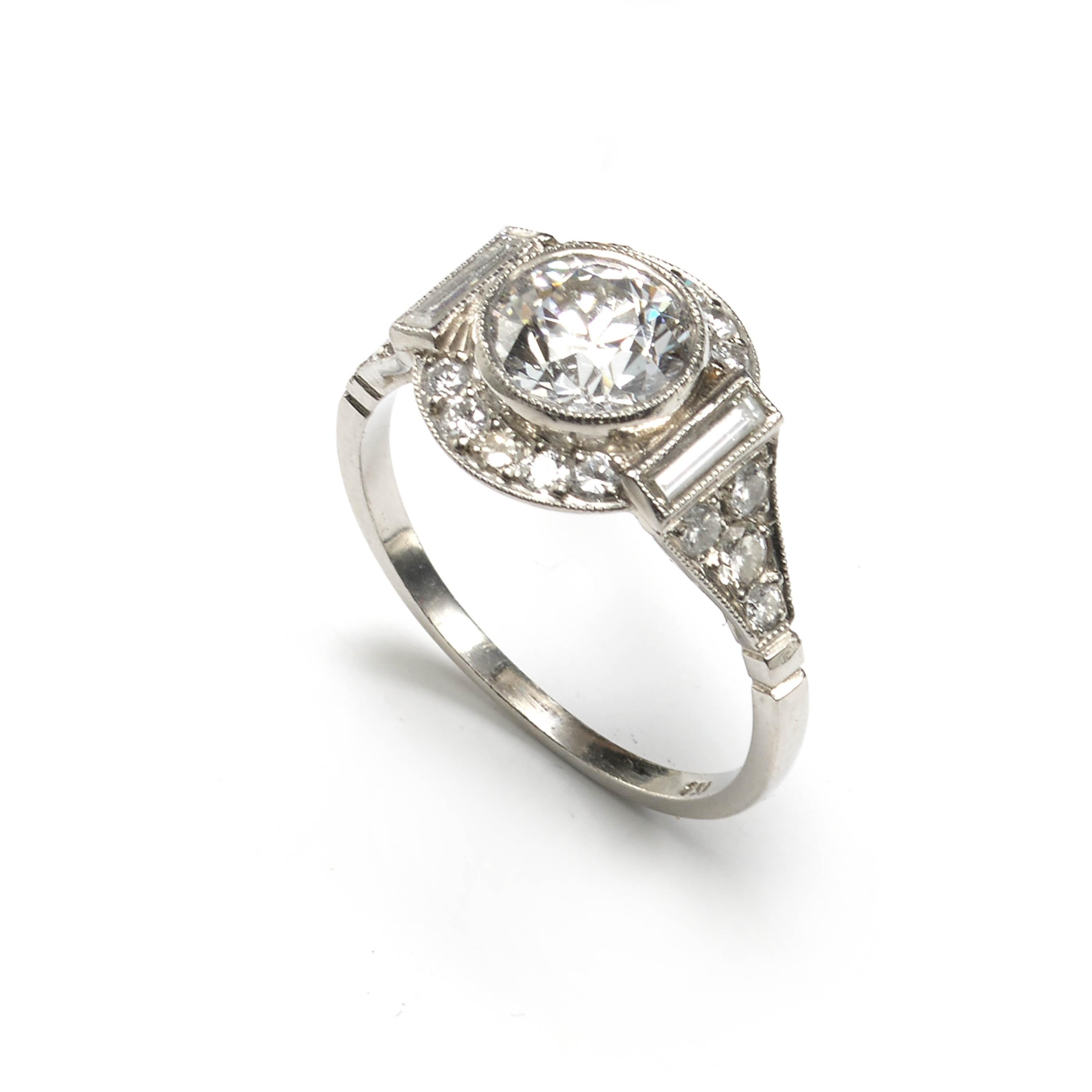 A modern, Art Deco style diamond cluster ring, set with a central round transitional brilliant cut diamond, weighing an estimated 1.48 carats, of estimated H colour and estimated VS1 clarity, surrounded by a halo of round brilliant cut diamonds,