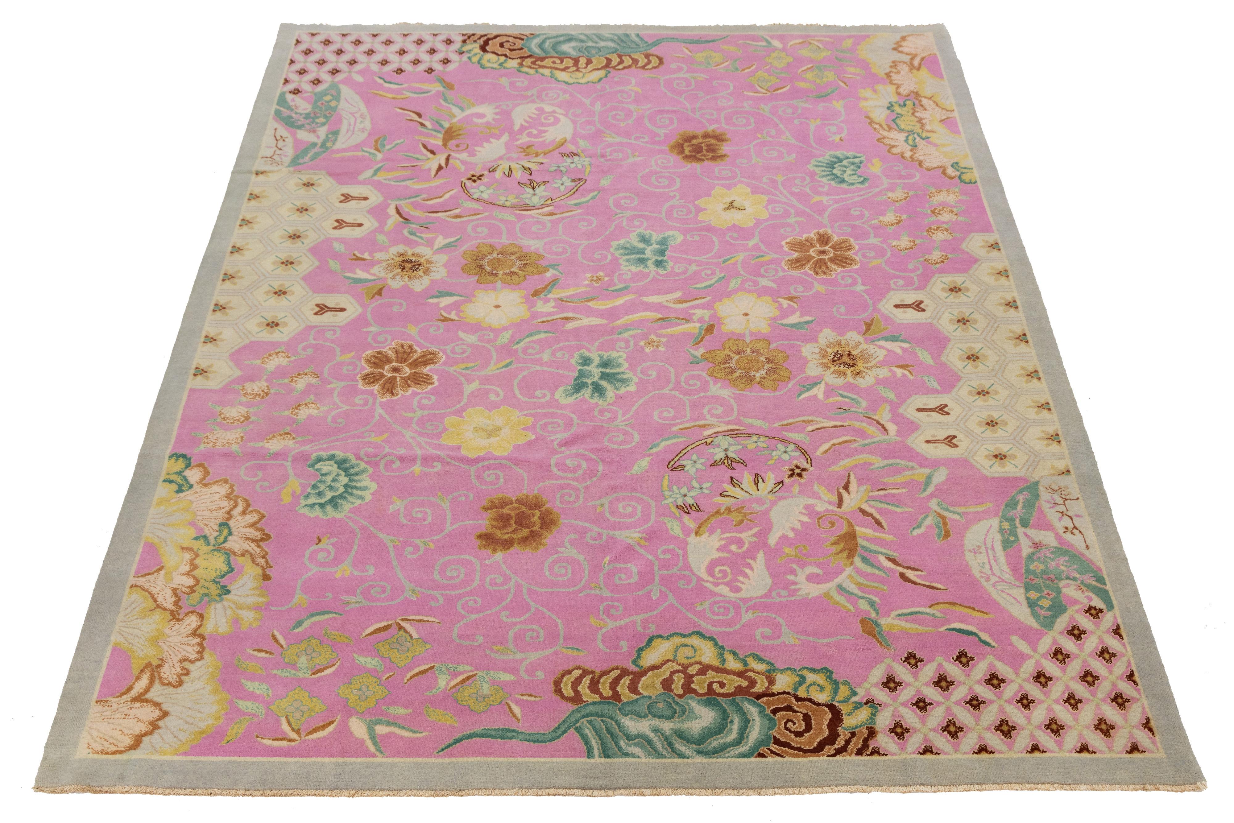 This beautiful hand-knotted wool rug features a stunning pink color palette, complemented by delicate brown and multicolored details that enhance its sophisticated all-over Art Deco design.

This rug measures 8'11