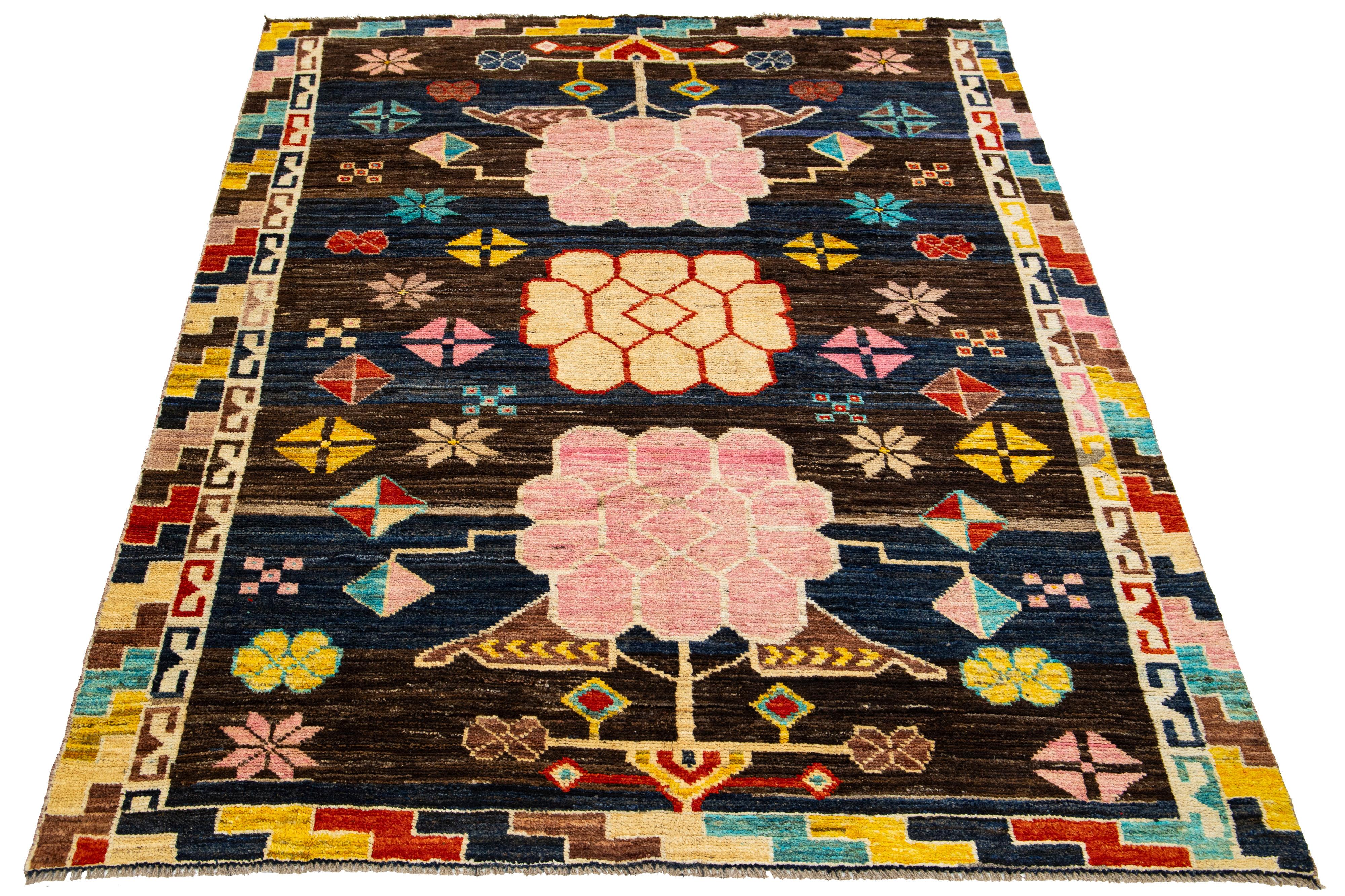 This wool rug showcases a modern take on the Art Deco style, boasting a striking blue and brown color field. The rug features a captivating allover pattern in a multitude of colors, adding vibrancy to any space.

This rug measures 5'11
