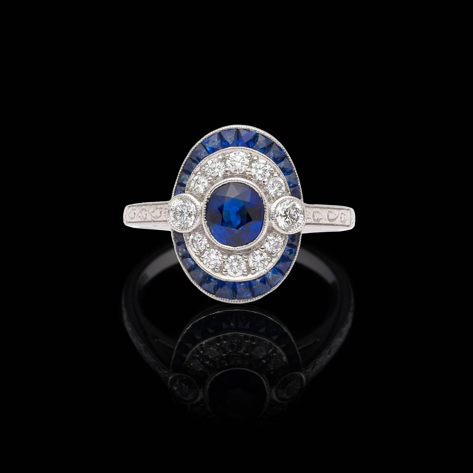 Bringing back the elegance of the art deco era, this platinum ring features an oval-cut sapphire, surrounded by round brilliant-cut diamonds, with yet another frame of calibre-cut sapphires. Sapphires weigh in total 1.42 carats, with the diamonds