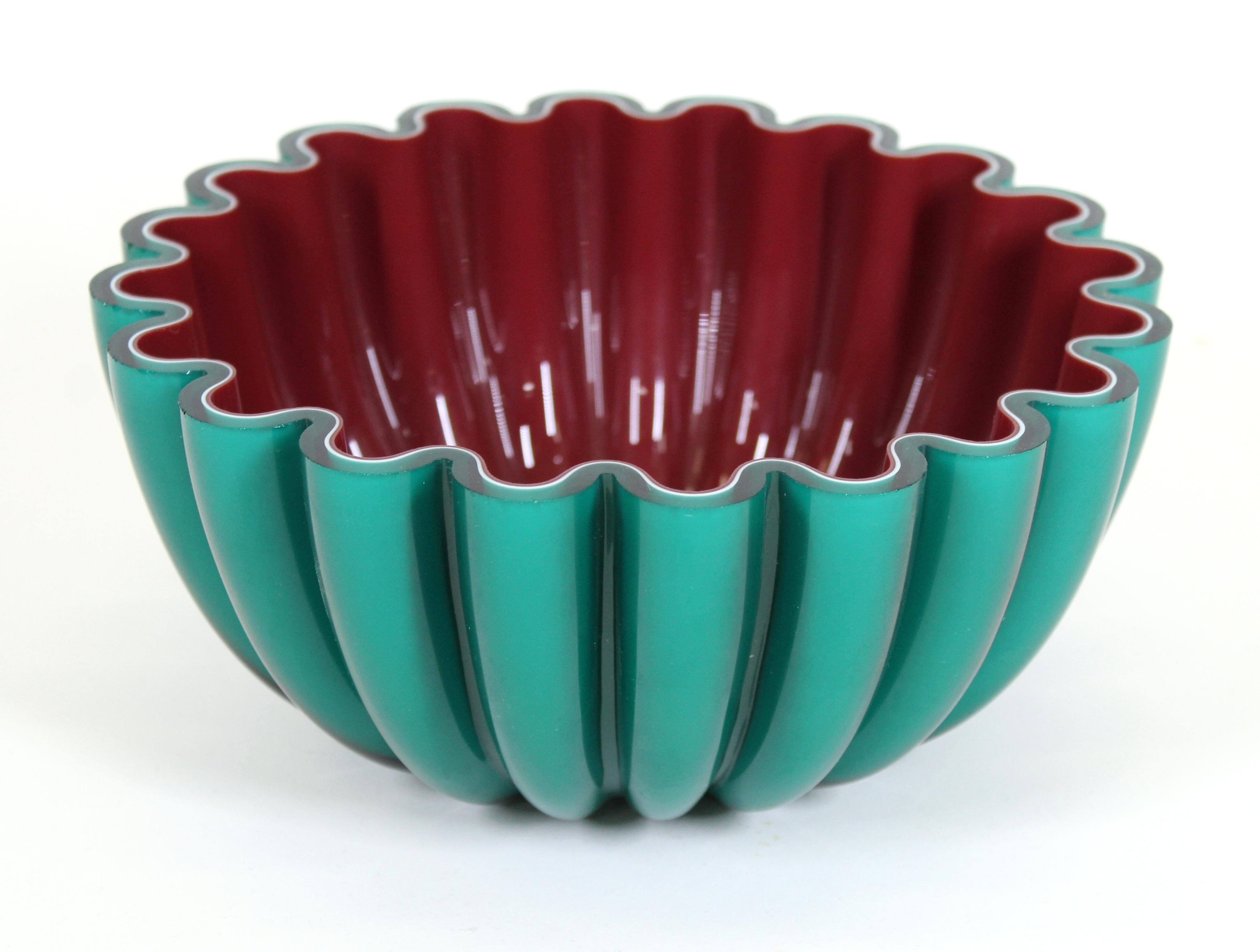 Modern art glass studio bowl in cased green, white and red glass. In great vintage condition with age-appropriate wear.