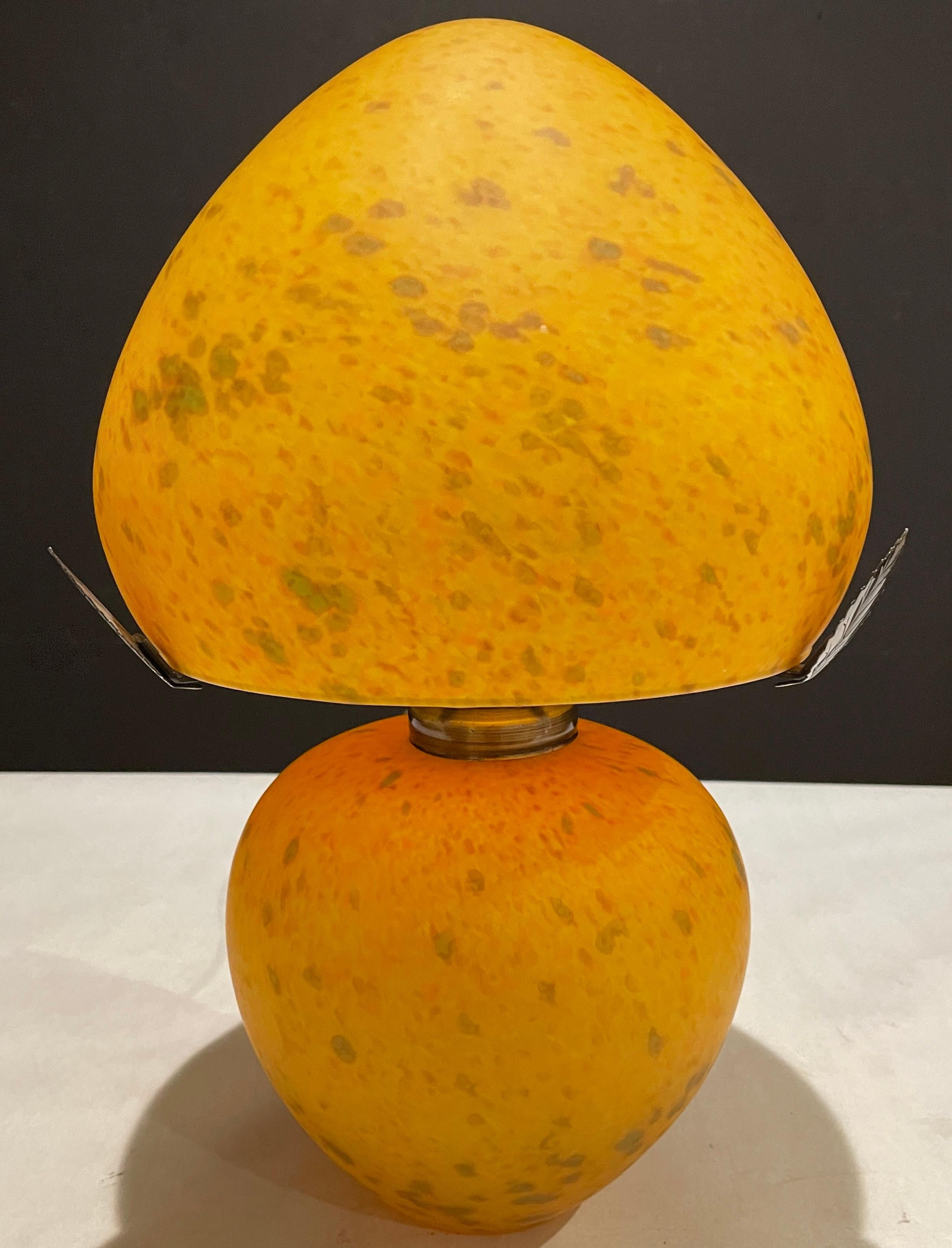 Mottled orange mouth blown art glass lamp and shade. Original makers label affixed to shade. French maker.