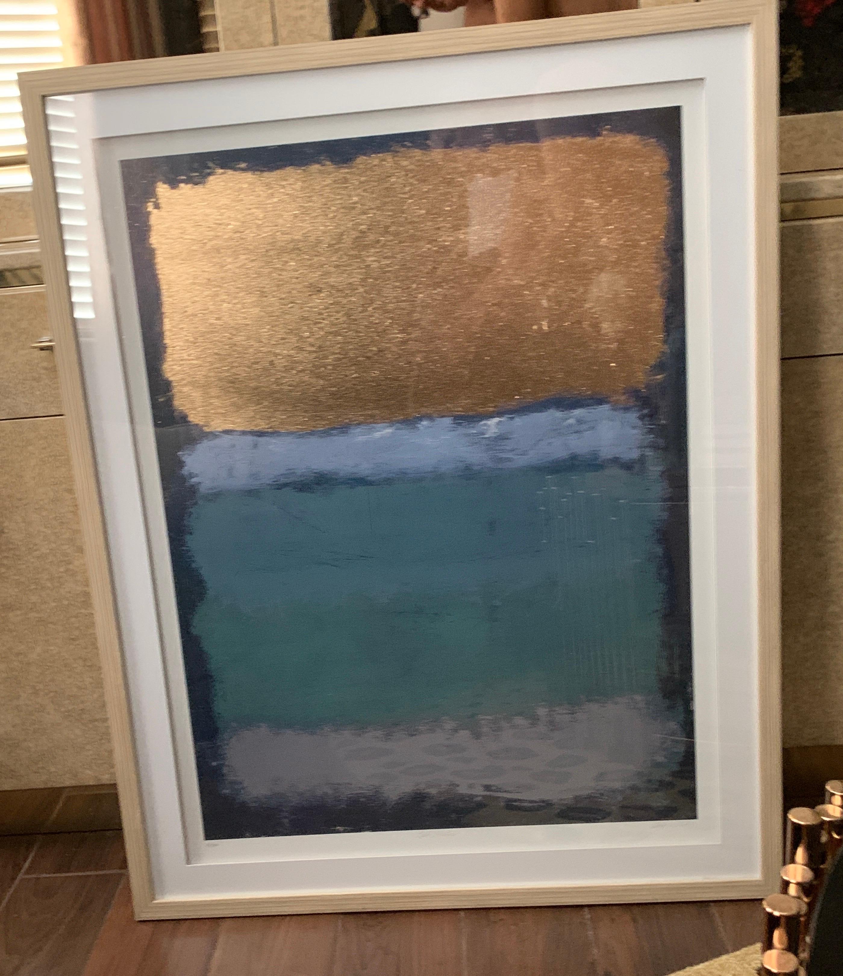 Obviously inspired by Rothko but made modern with a beautiful gold metallic addition in shades of blue from navy to light blue. Entitled “Blue Stratus” it is #32/3600 numbered edition also embossed and signed by artist. (illegible) double matt and