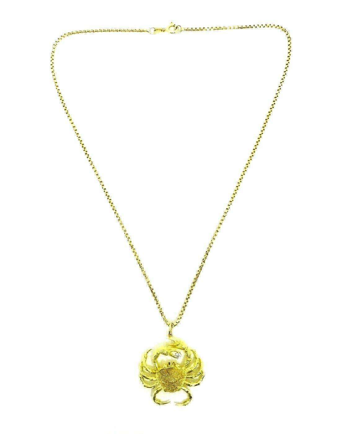 Modern artisan crab/cancer pendant made of 18k yellow gold features diamond. Comes with a 14k yellow gold box link chain necklace. Diamond is round brilliant cut, carat weight is approximately 0.15 points. 
The pendant stamped with a maker's mark