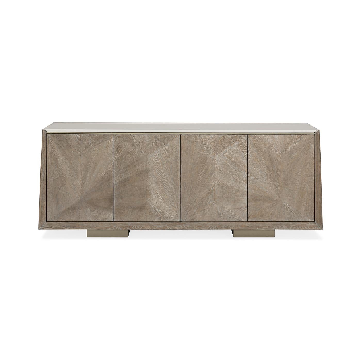 Modern Ash Buffet, a straightforward silhouette showcases its extraordinary linear veneer patterns and is topped with a cream stone top that ensures usability and durability. Block feet and a soft tonal finish of Ash Driftwood convey its relaxed