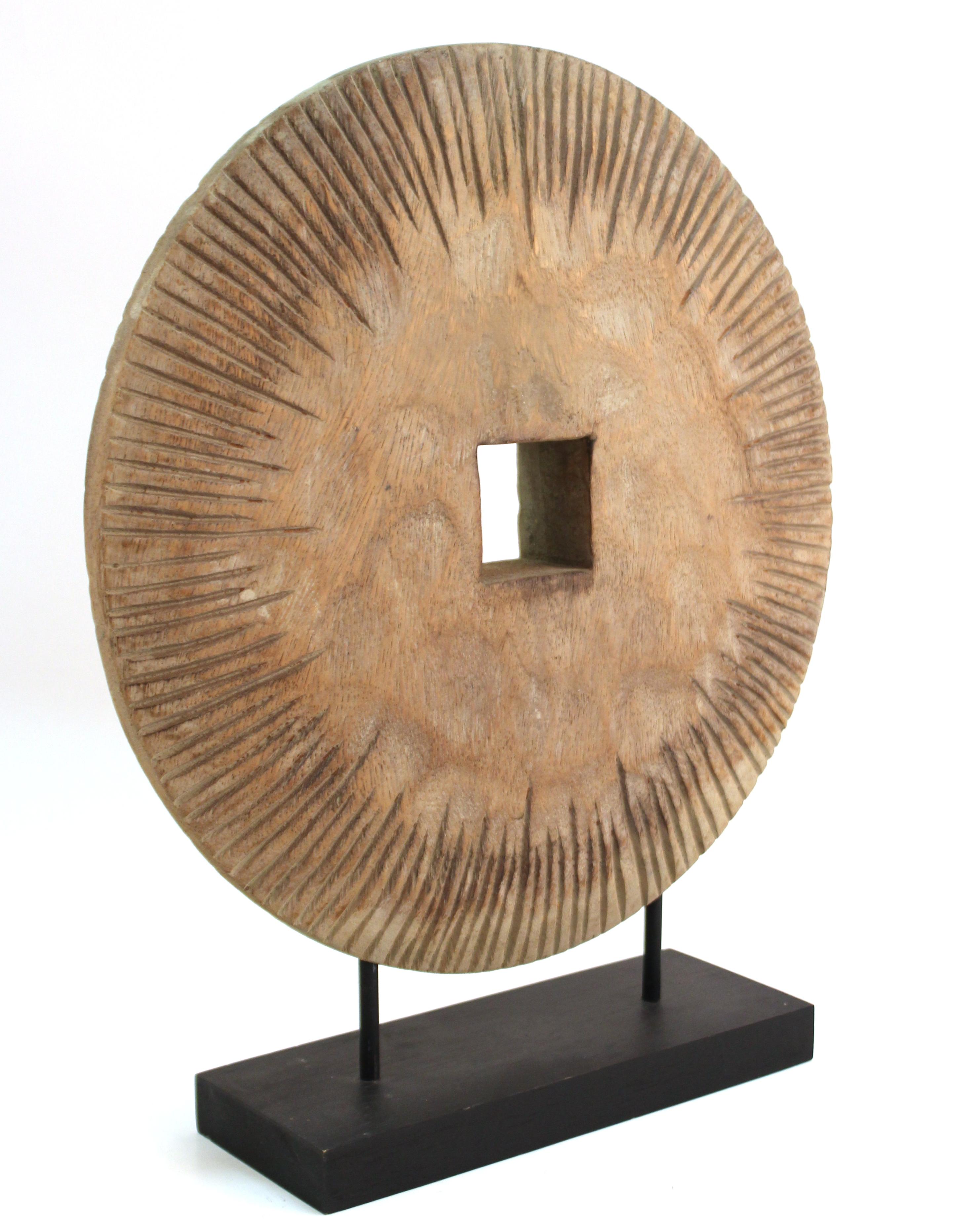 Modern Asian archaic style tabletop sculpture of a wooden carved disc atop a display stand. The piece has a square center hole and carved ridges on the edges. It was likely made during the late 20th century. In great vintage condition with
