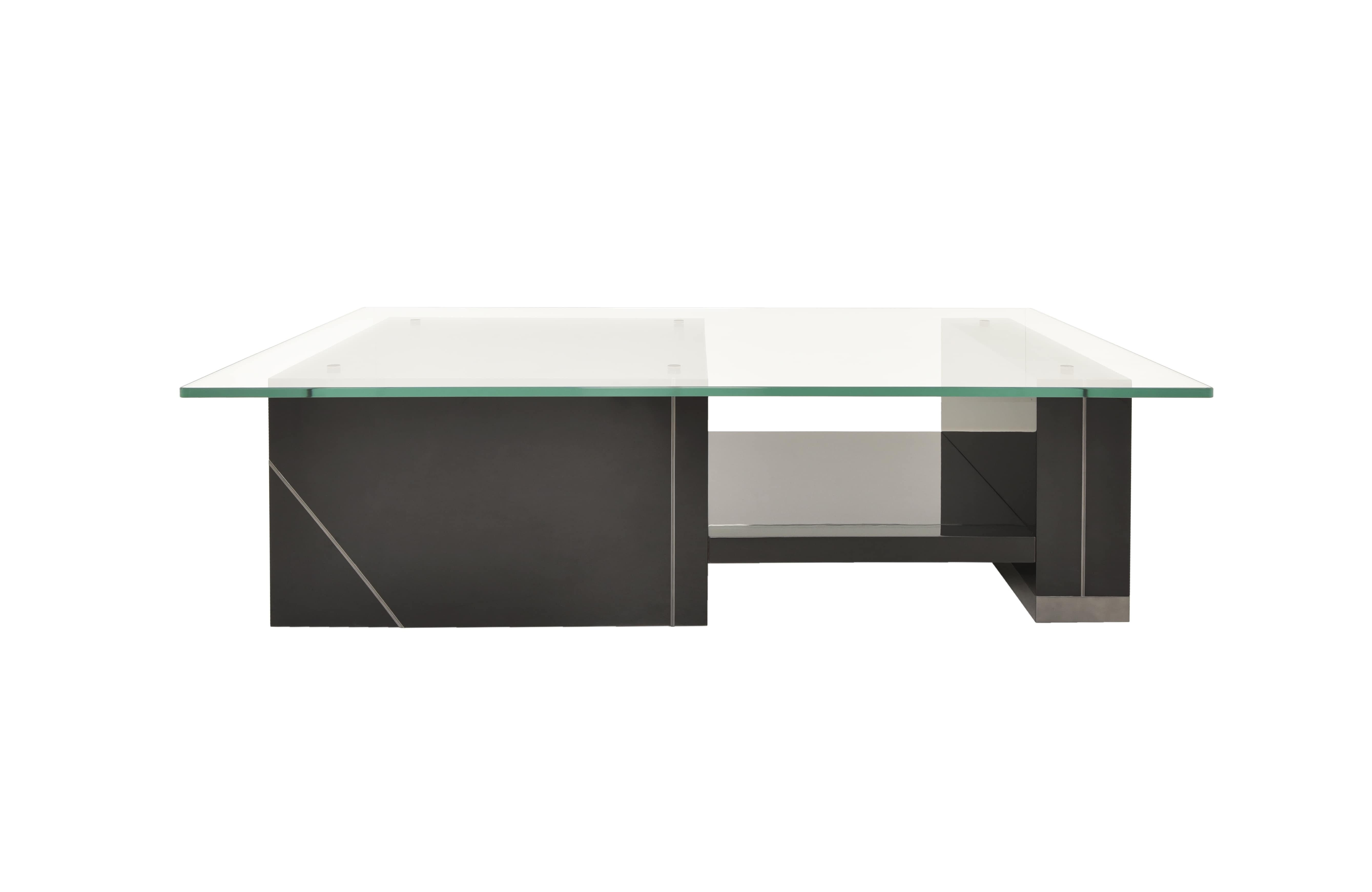 A study in balance and material contrast, this center table combines the warmth of lacquered finish with the subtle elegance of smoke brass. Its design is defined by a bold structure connected with a glass and supporting a rectangular glass top.
The