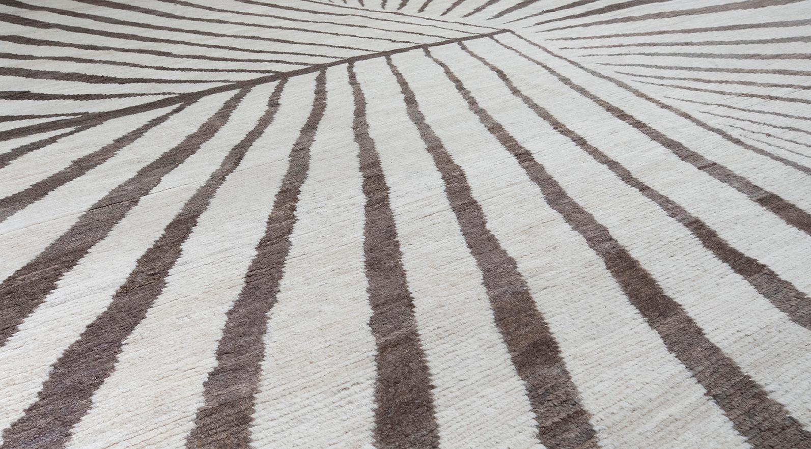 Our 'Astor' rug is handknotted in Afghanistan using natural dyes and handcarded wool. This rug has both a modern and tribal feel to it making it versatile for any aesthetic. It features an abstract geometric, starburst design in neutral tones.