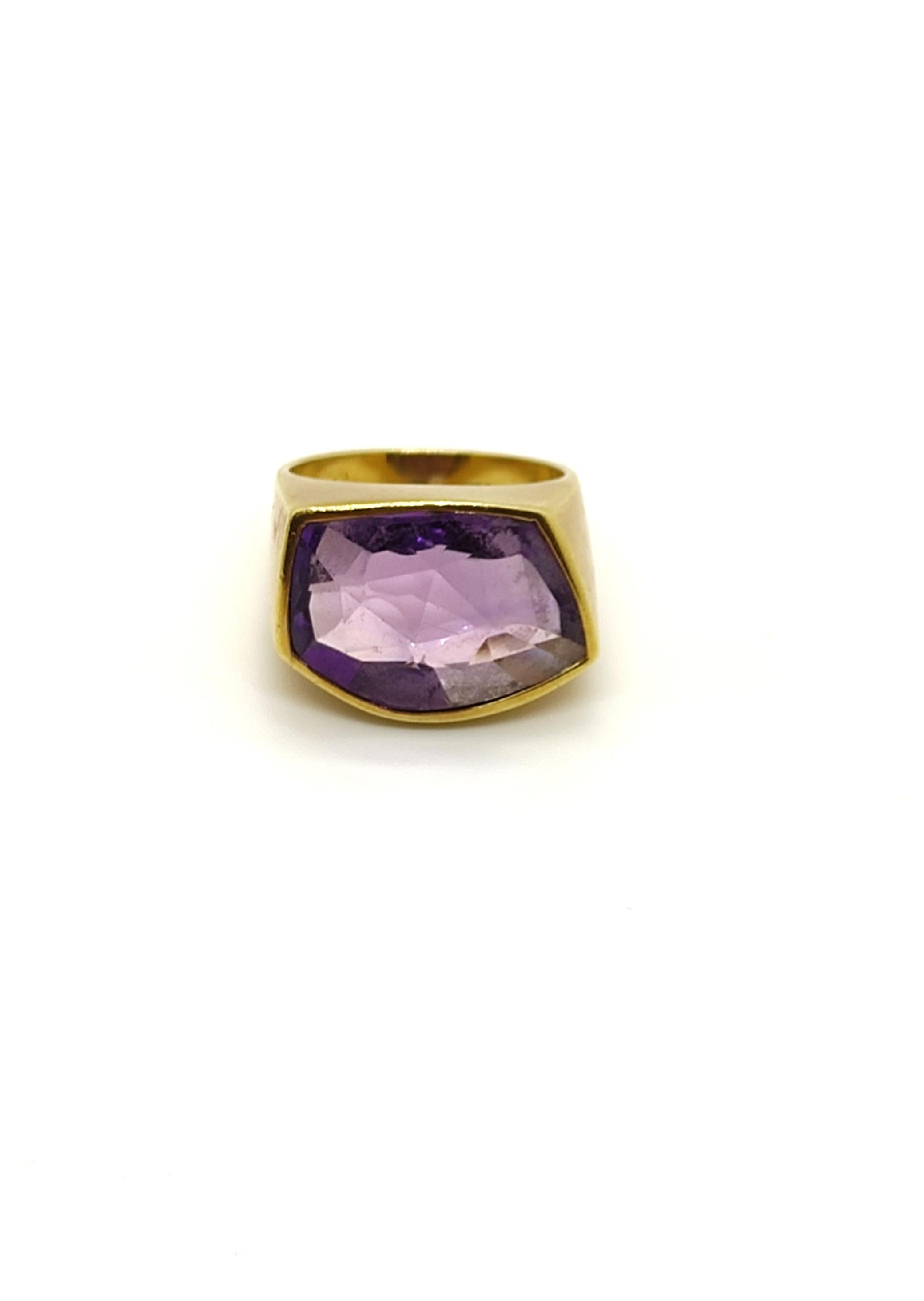 This modern asymmetrical ring crafted in 18k yellow gold, is decorated with an awesome asymmetric amethyst gem stone, embedded in the ring. This beautiful and original ring will complete any outfit and will be suitable for any occasion.

This ring