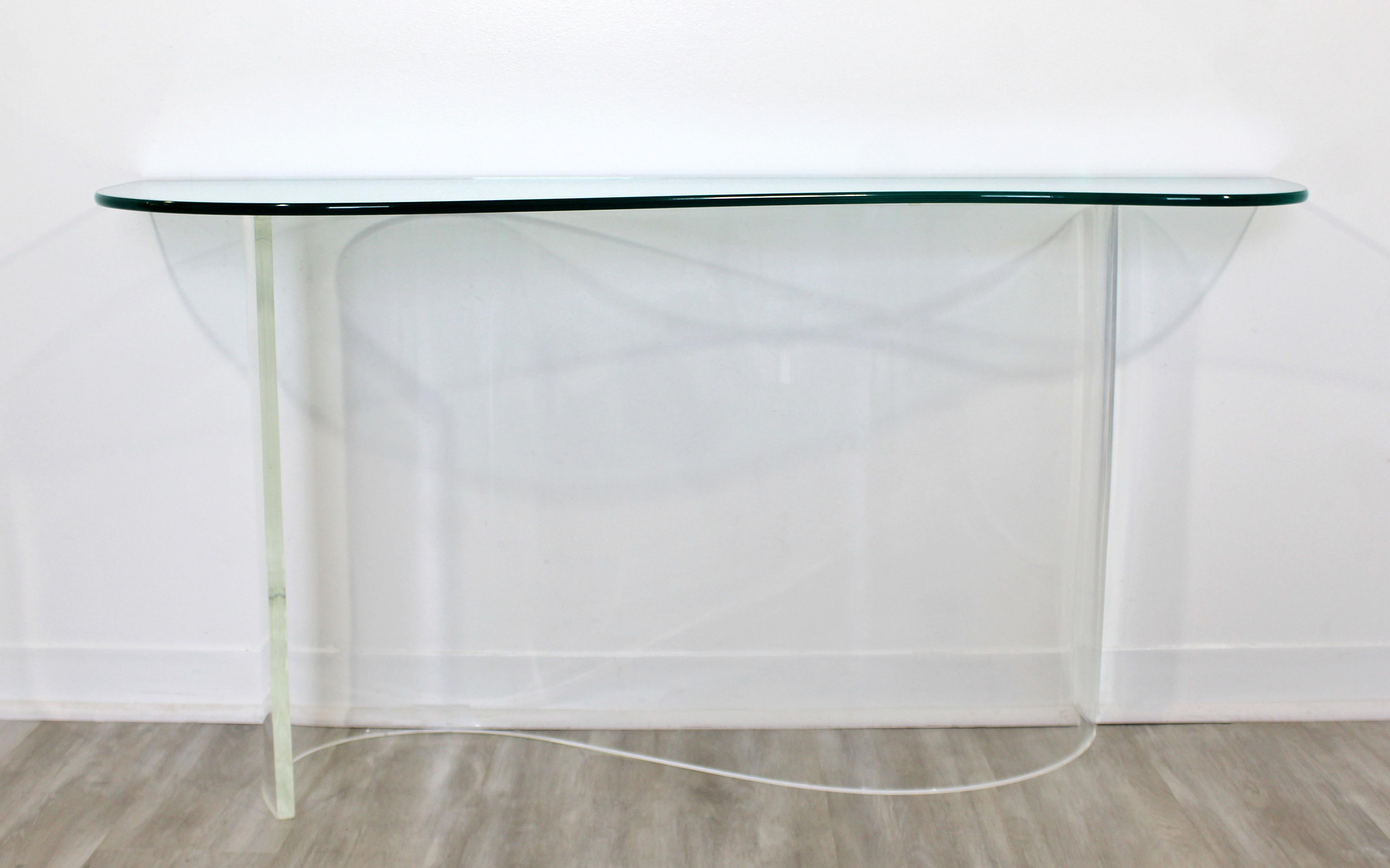 For your consideration is an awesome, asymmetrical, Lucite and glass console table in the style of Charles Hollis Jones, circa 1970s. In very good condition, with some minor scratches in the glass. The dimensions are 52
