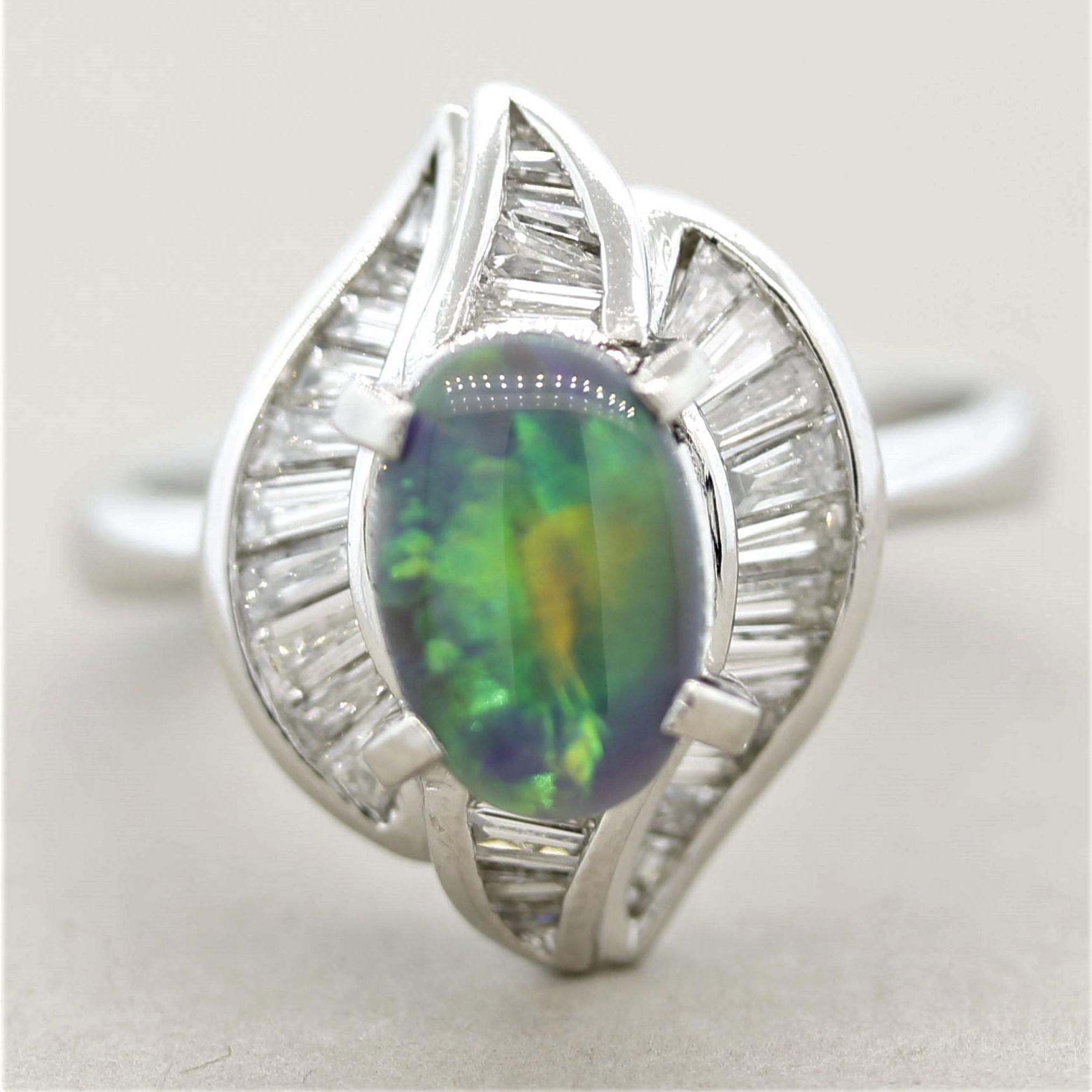 A modern styled platinum ring featuring a 1.15 carat Australian black opal with excellent play-of-color. Large and bright flashes of green, yellow and some blues can be seen across the entirety of this small but gem opal. Accenting the opal are 0.93