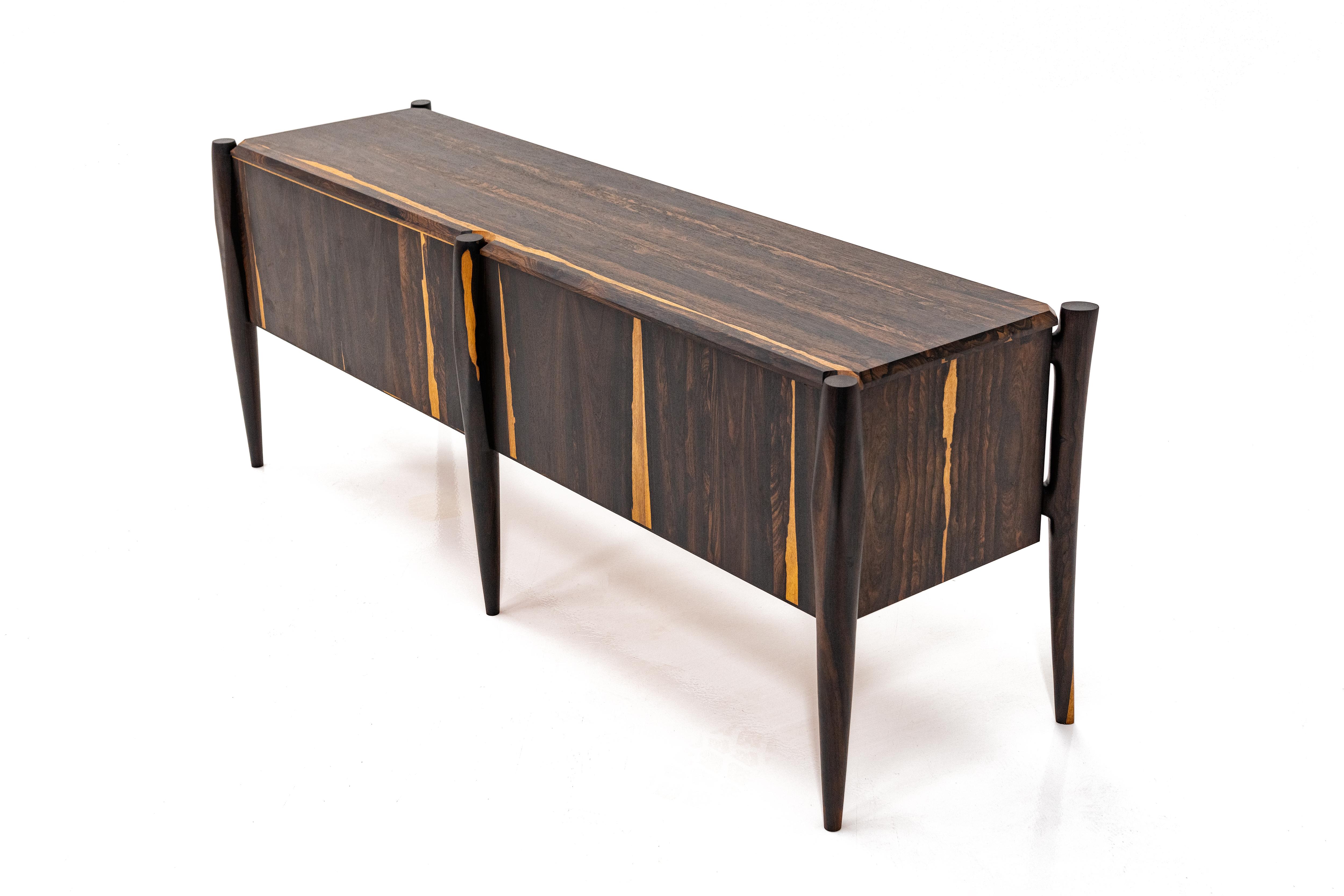 Modern credenza with hand turned legs. Available in other wood species.