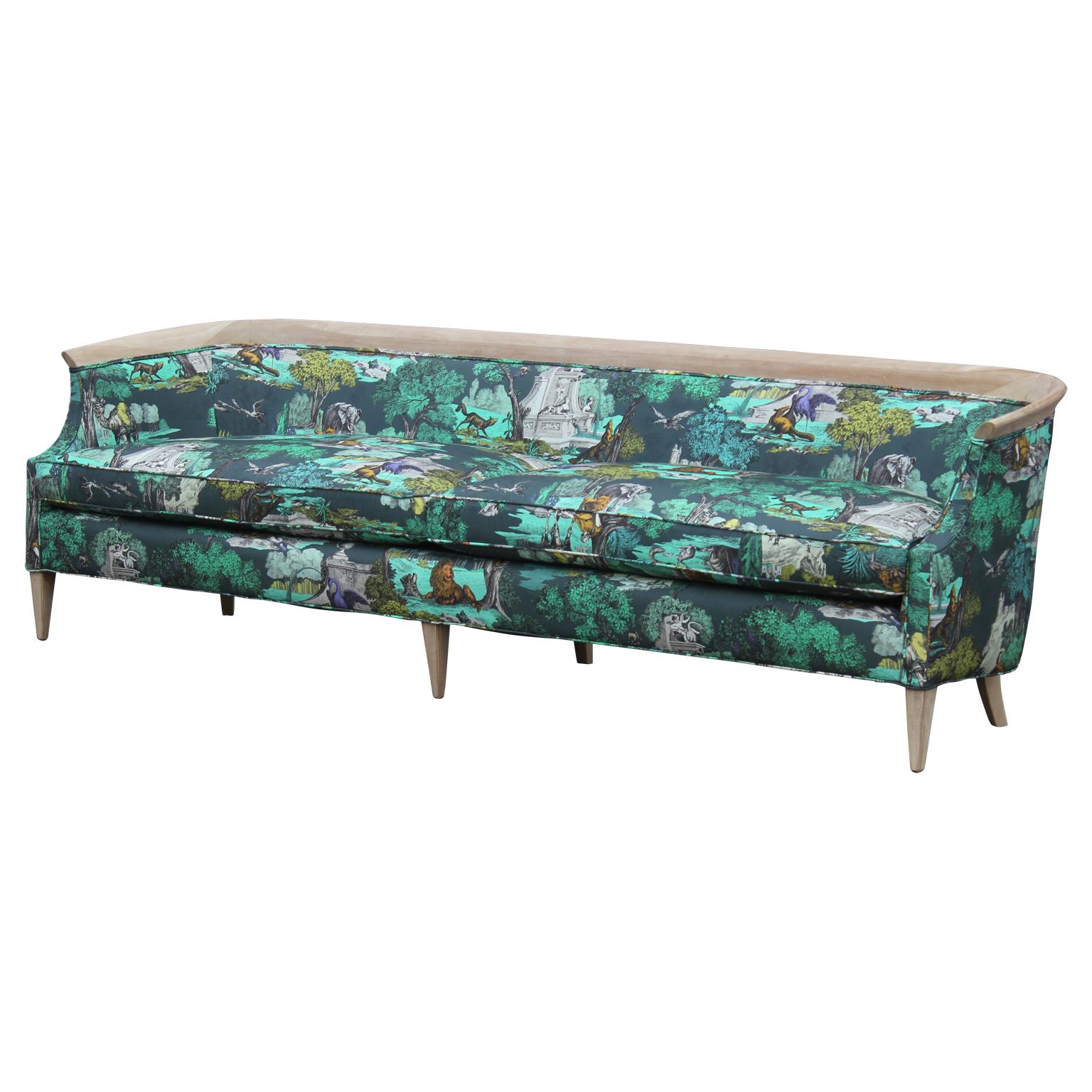 Stunning modern barrel back sofa with a bleached mahogany frame and freshly upholstered in a whimsical and colorful blue / green / yellow Cole & Son 