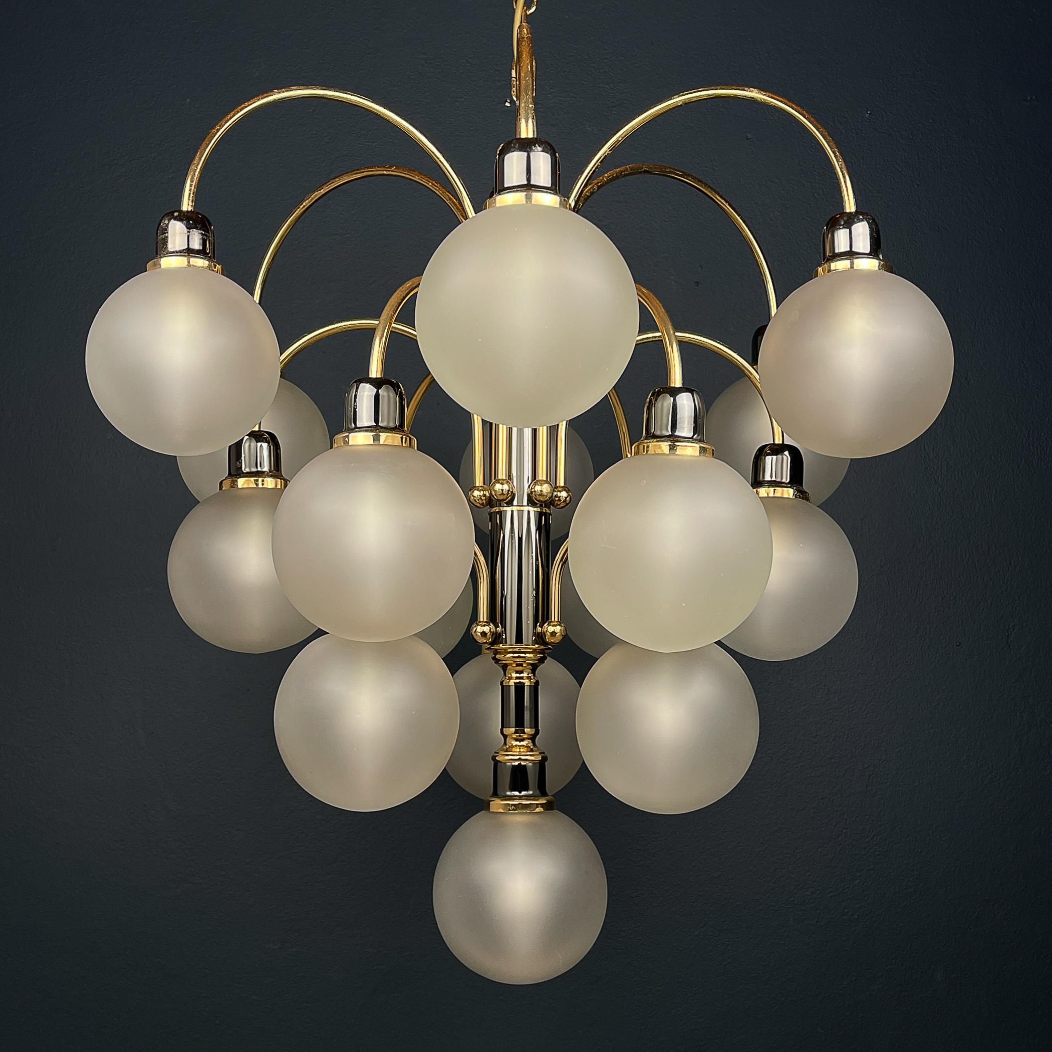 Introducing a striking piece of mid-century modern artistry: the modern ball chandelier by Orion Austria, crafted during the vibrant 1980s. With its sleek spherical design and exquisite craftsmanship, this chandelier embodies the essence of vintage