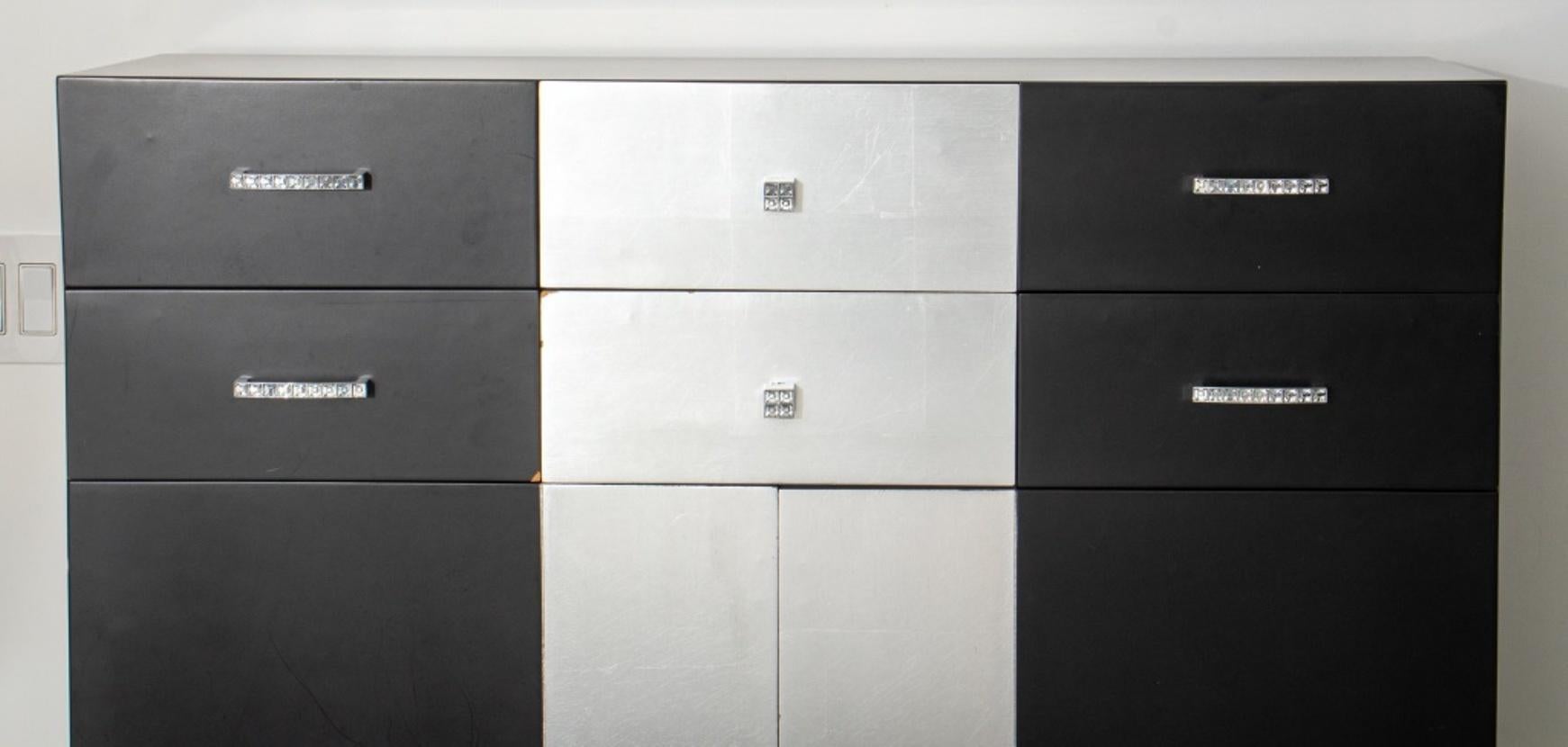 Modern Baroque revival black lacquered and silvered cabinet raised on cabriole silvered feet, with two doors surmounted by six drawers, having chrome & glass handles in the Art Deco taste. 51