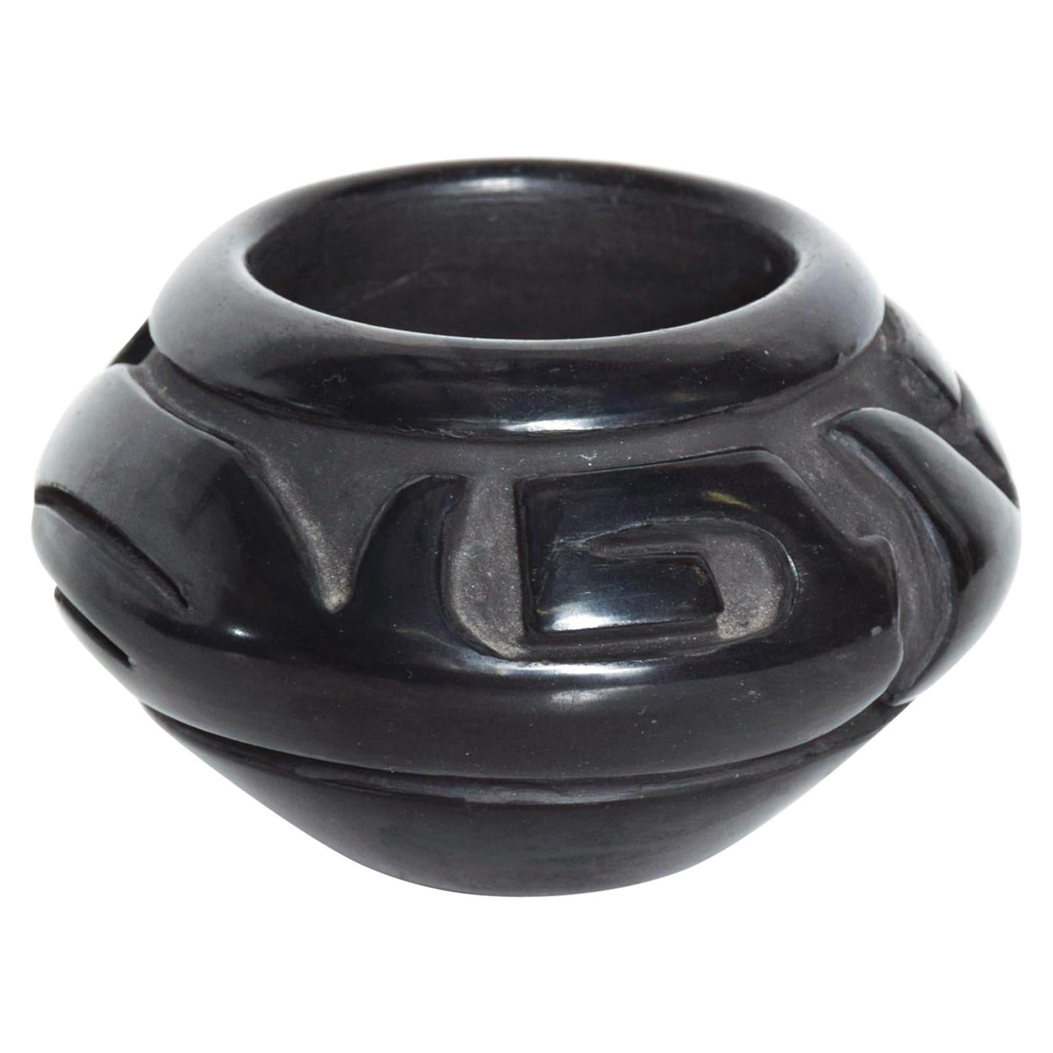 AMBIANIC presents
Santa Clara Pueblo Black Pottery hand coiled style of Southwest Native Margaret Tafoya New Mexico 
 Blackware Pottery Jar round glossy vase of ceramic clay
Artist signed on the bottom Denise Martinez Santa Clara Pueblo
Dimensions: